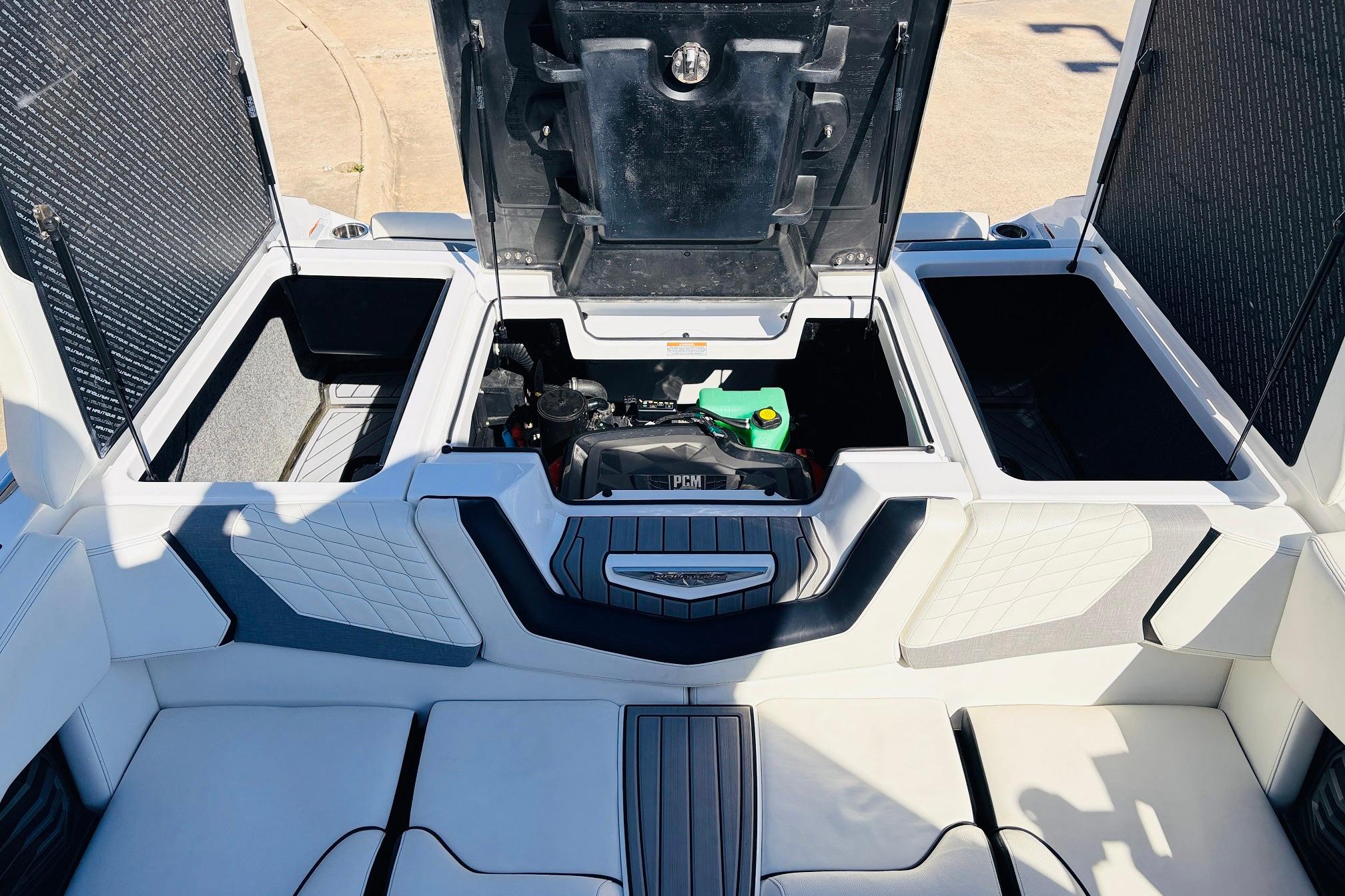 2023 Nautique Super Air Nautique G25 engine compartment with open storage hatches.