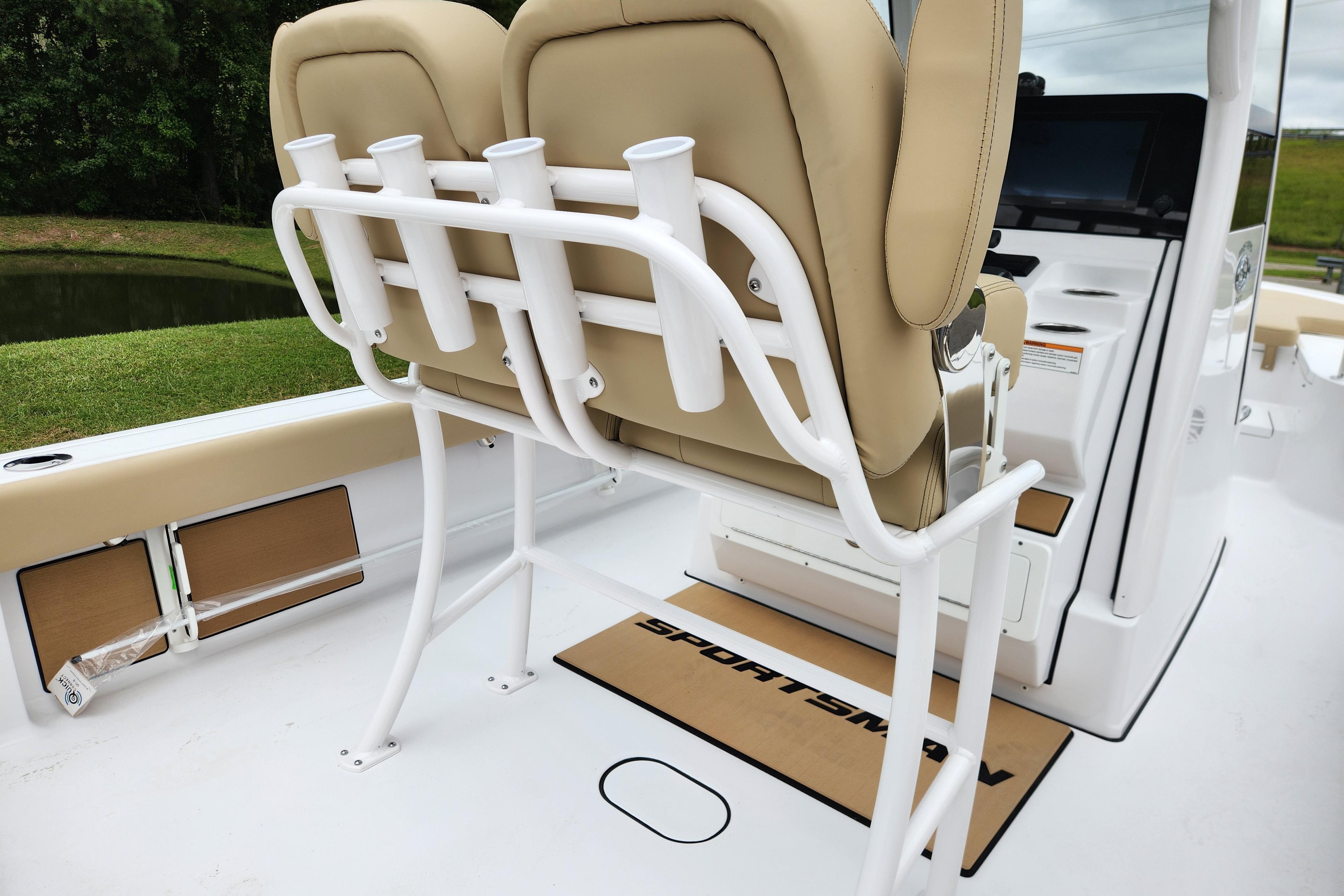 2026 Sportsman Masters 247 Bay Boat interior with beige seating and rod holders.