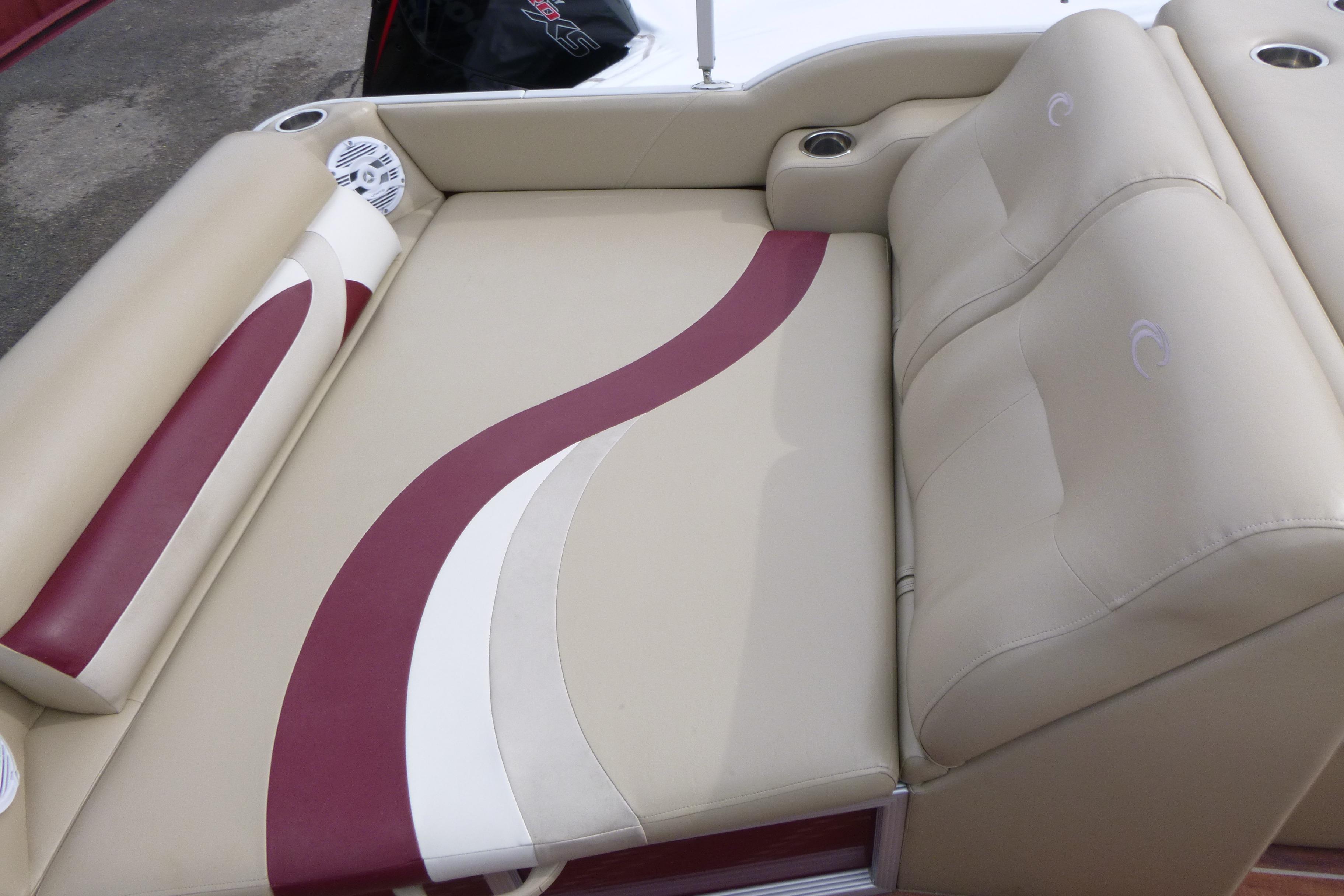 Luxurious seating on 2012 Crest 230SLR Classic boat with beige and maroon upholstery.