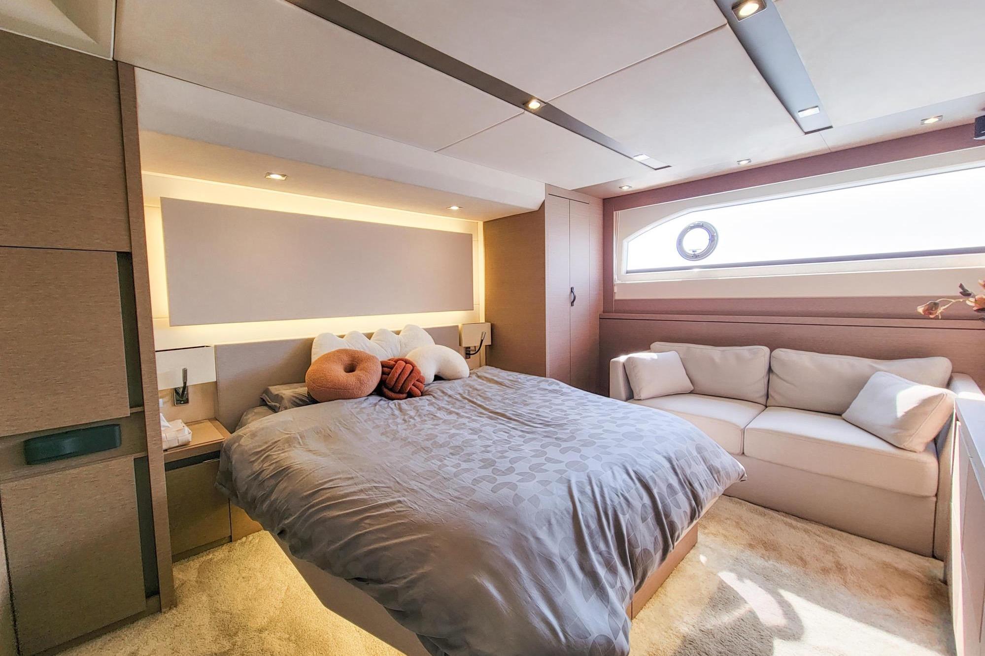 Luxurious bedroom interior of 2019 Prestiage 630 yacht with modern design and cozy furnishings.