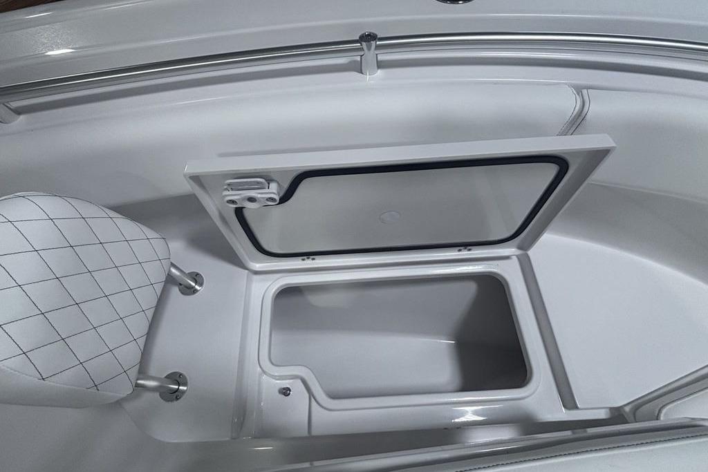 2026 Sportsman Open 252 Center Console storage compartment with open hatch and cushioned seating.