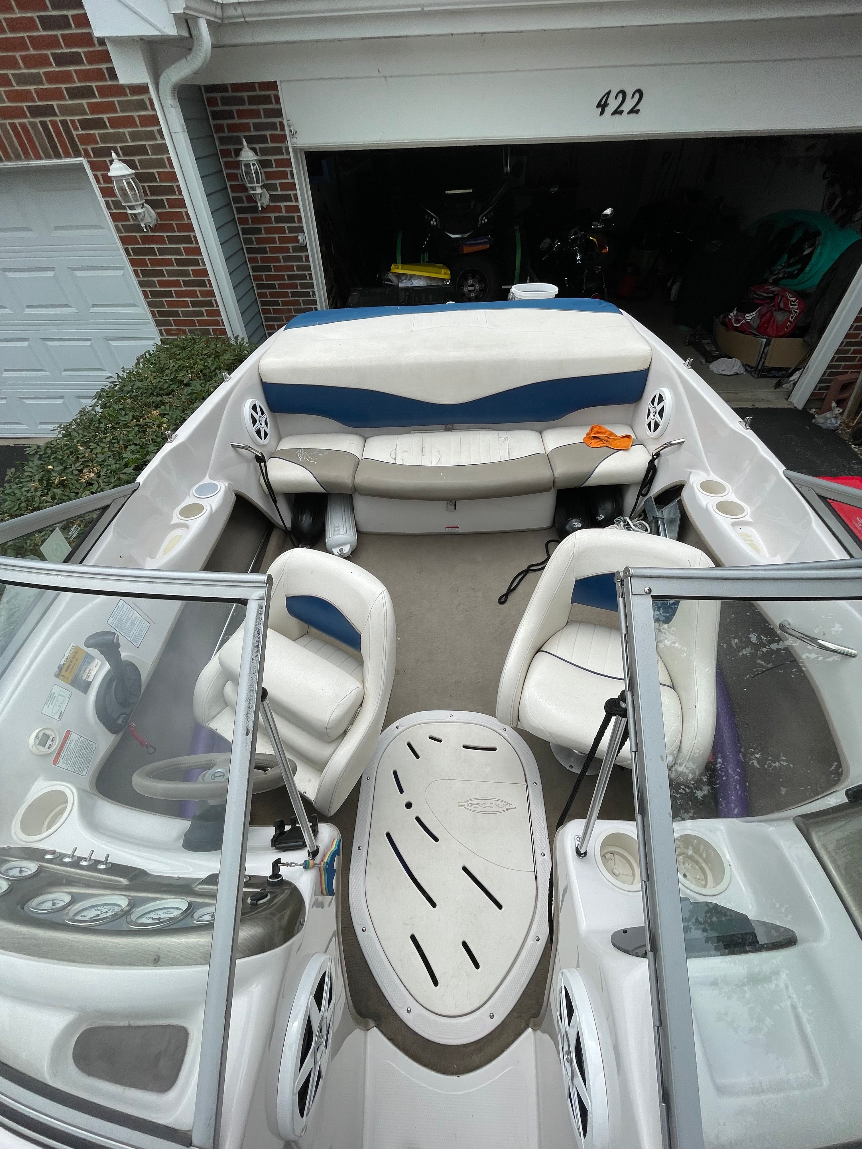 Interior view of a 2005 Tahoe Q6 Sport boat with white and blue seating.