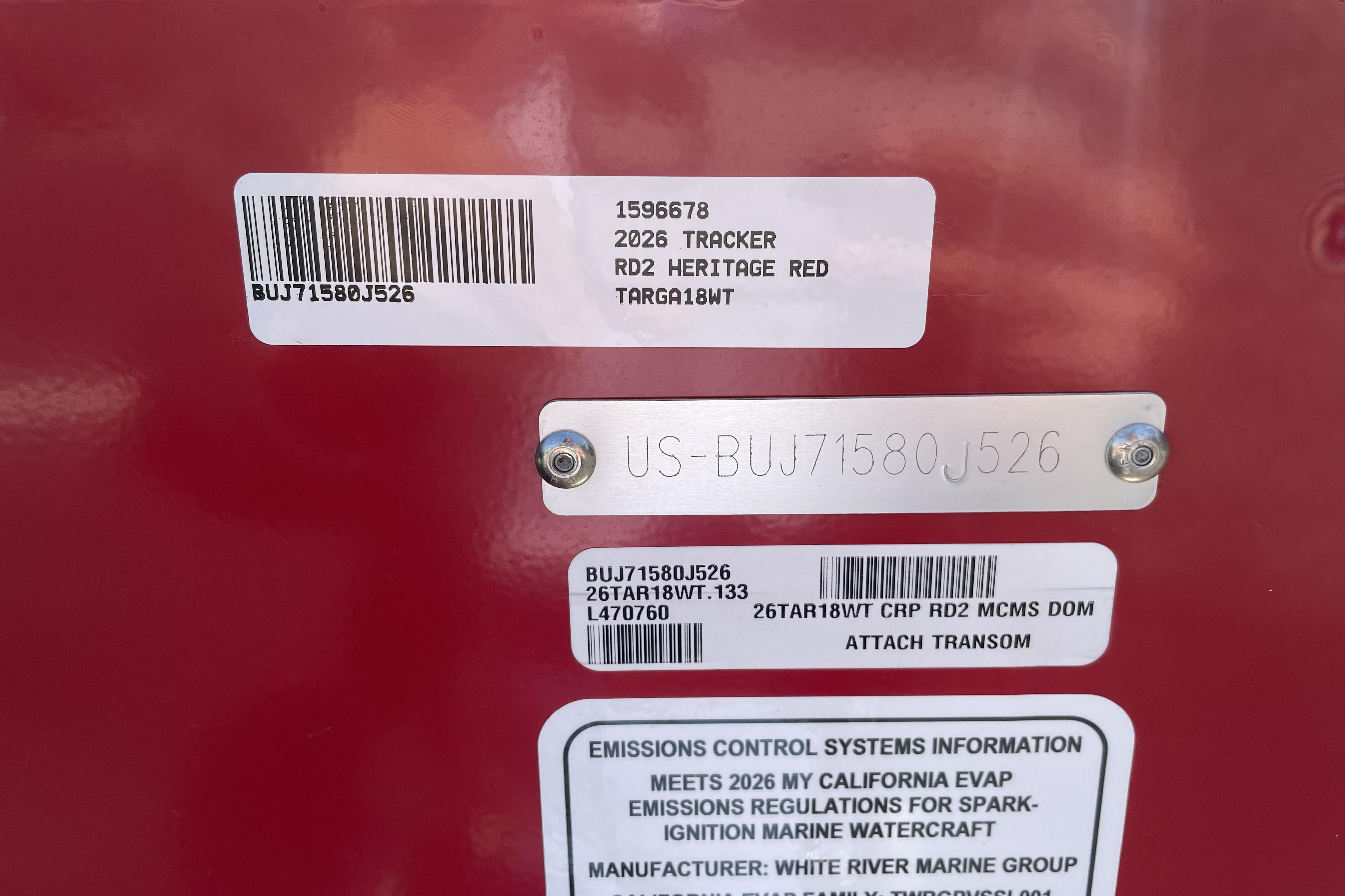 2026 Tracker Targa V-18 WT identification labels on red surface.