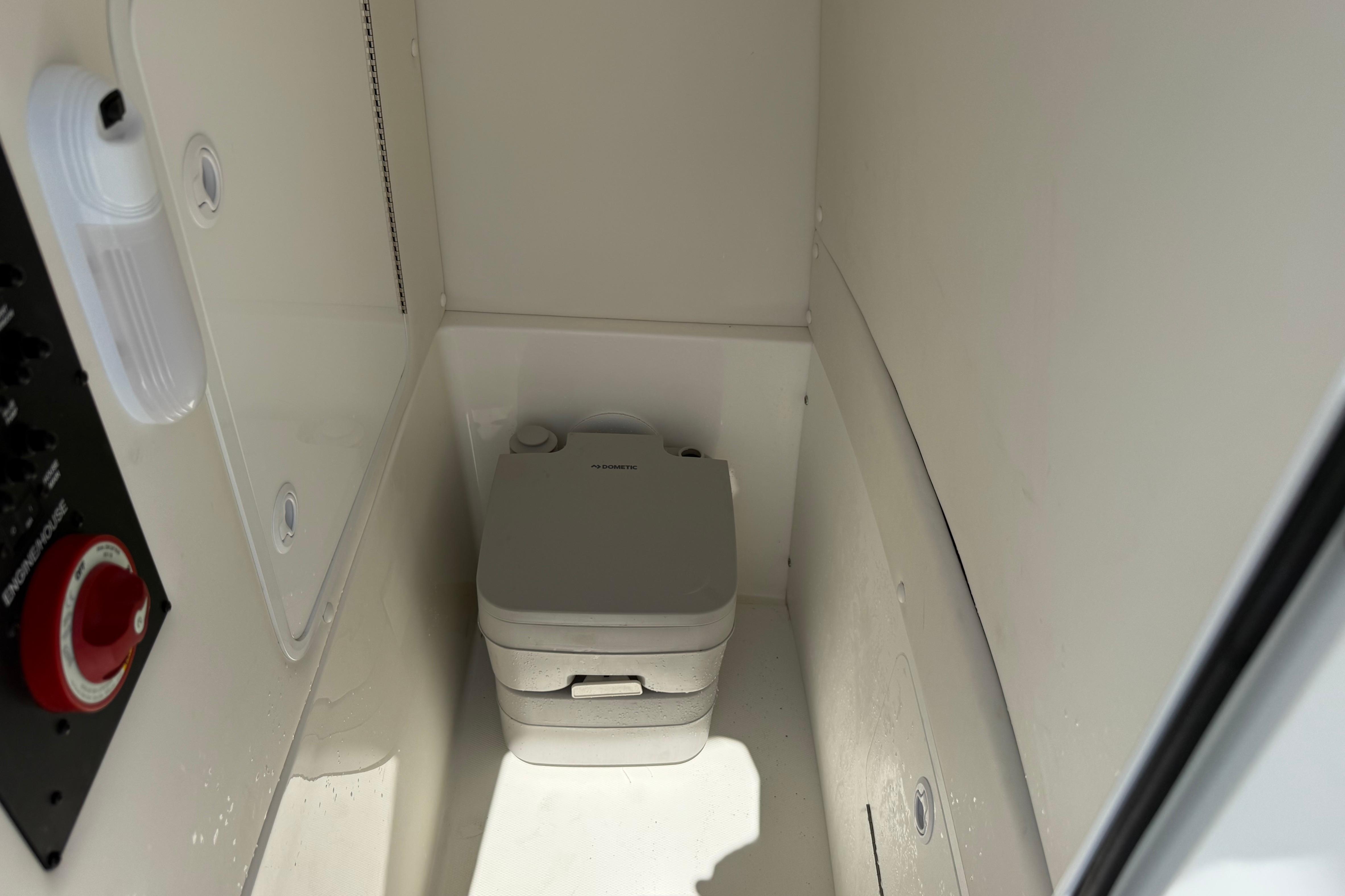2023 Regulator 26XO boat interior with compact marine toilet.