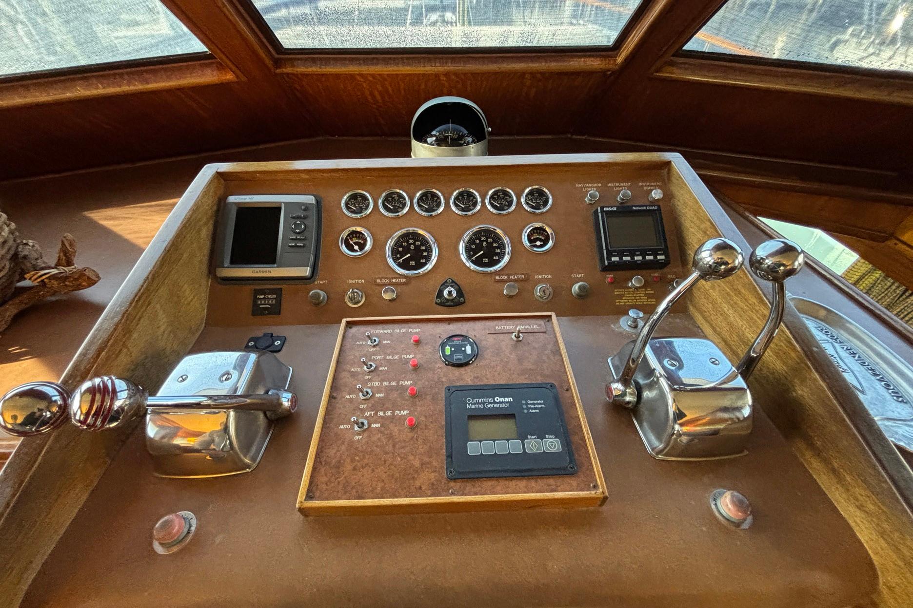 1979 Hatteras 53 Motor Yacht helm with gauges, controls, and navigation equipment.