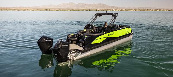 2024 Godfrey XP 27' boat with twin 400HP engines on a serene lake.
