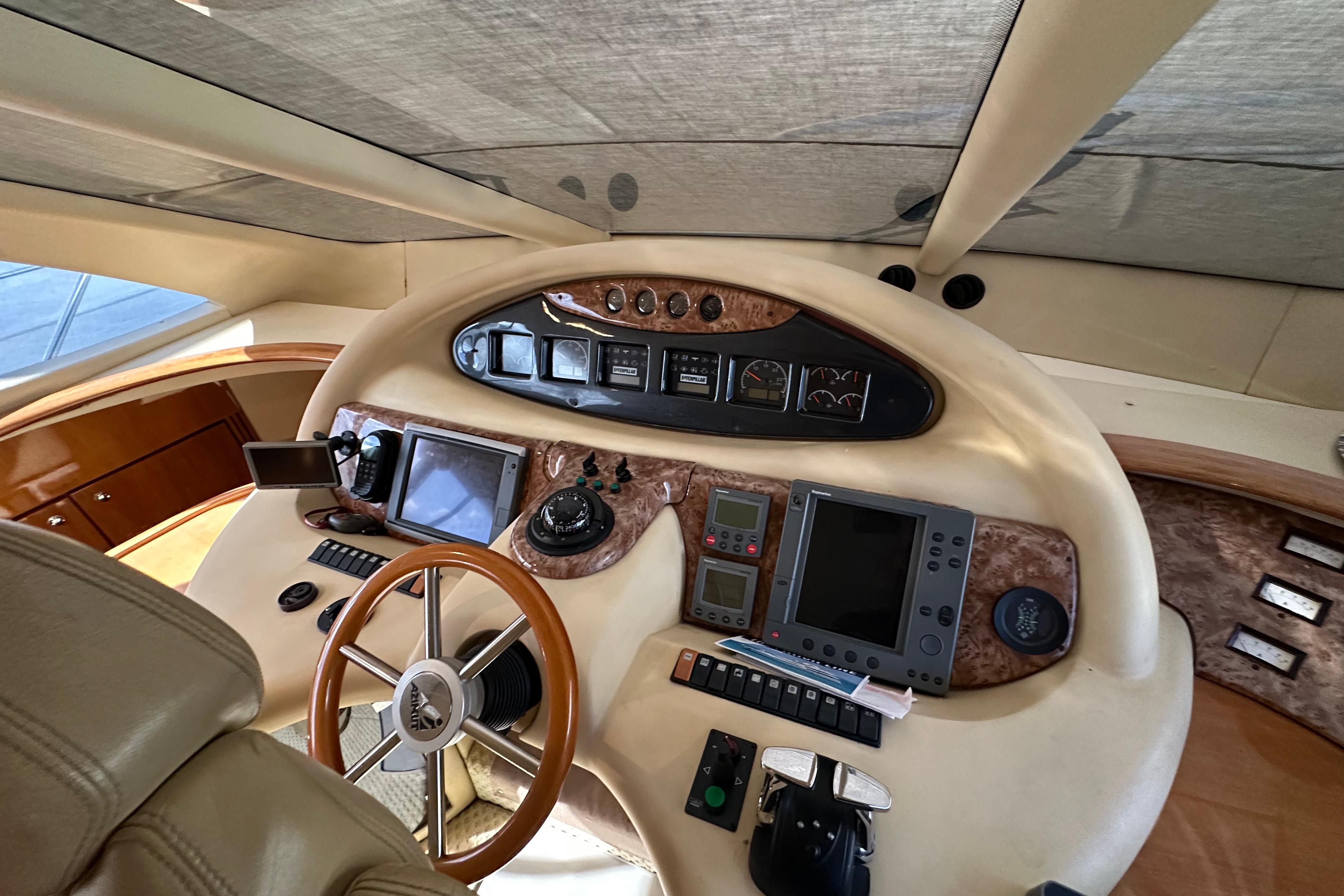 Cockpit of 2004 Azimut 55E yacht with navigation instruments and steering wheel.