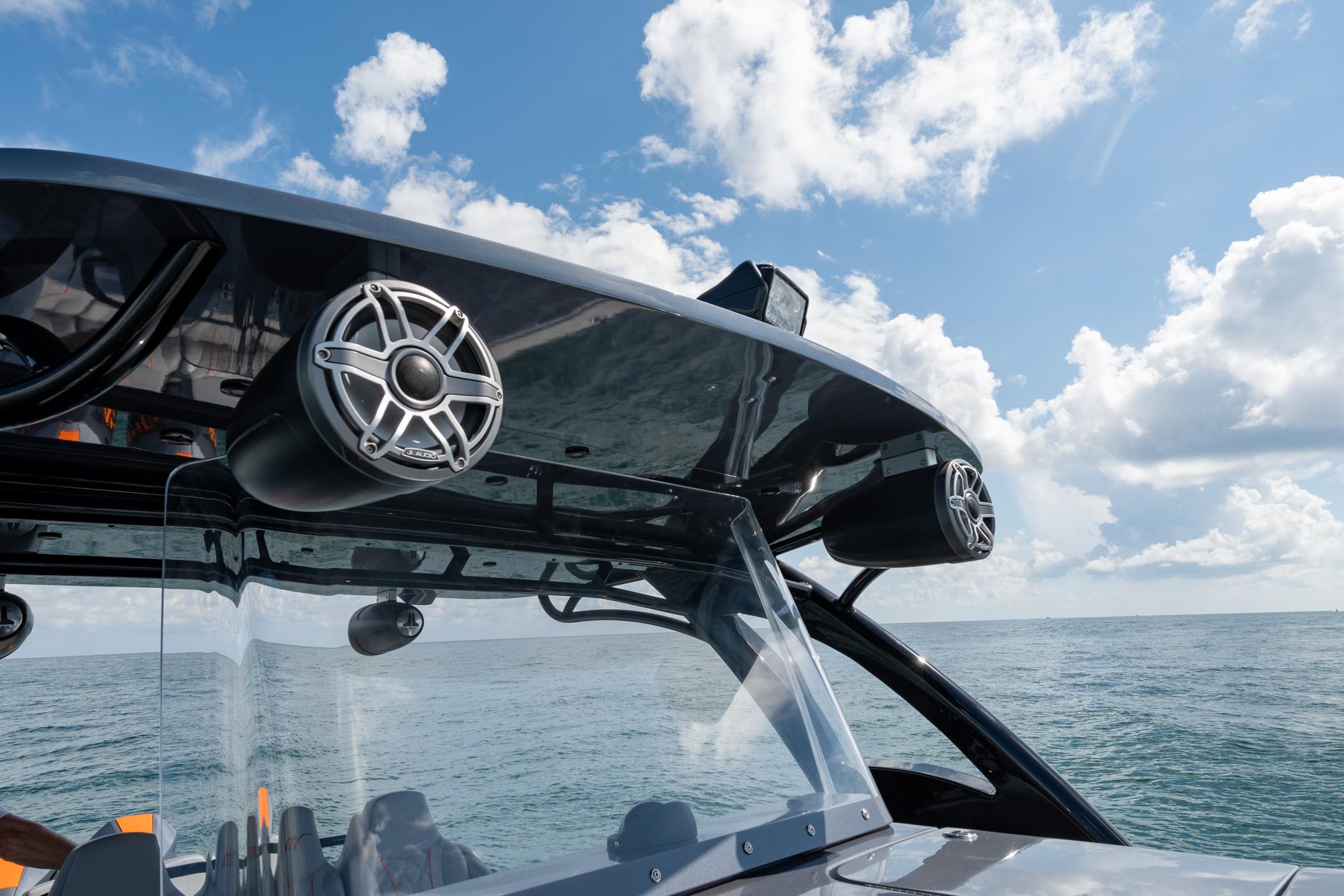 2022 Midnight Express 37' Open boat with speakers, ocean view, and blue sky.