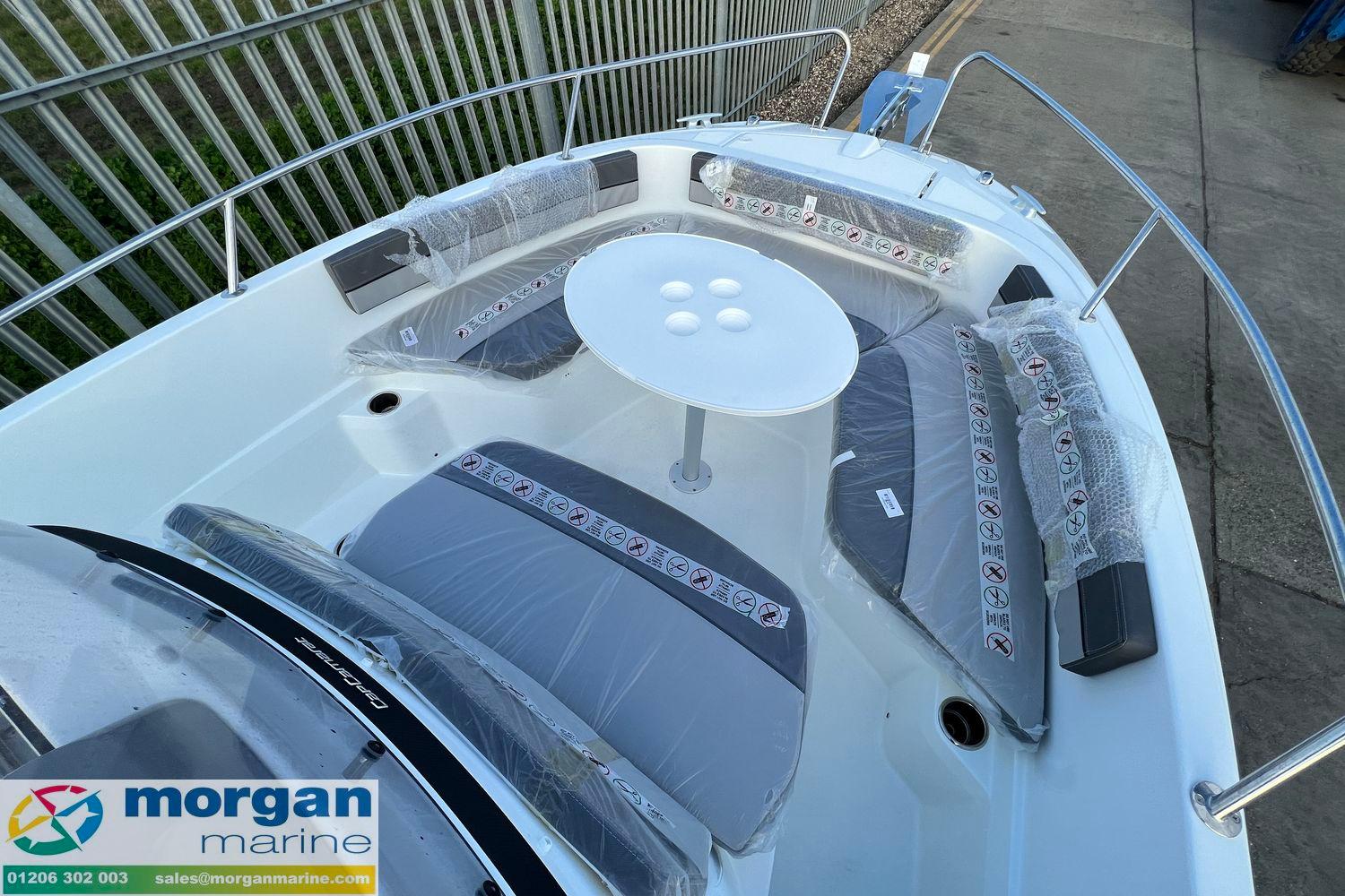 2024 Jeanneau Cap Camarat 6.5 CC boat interior with seating and table, Morgan Marine branding.