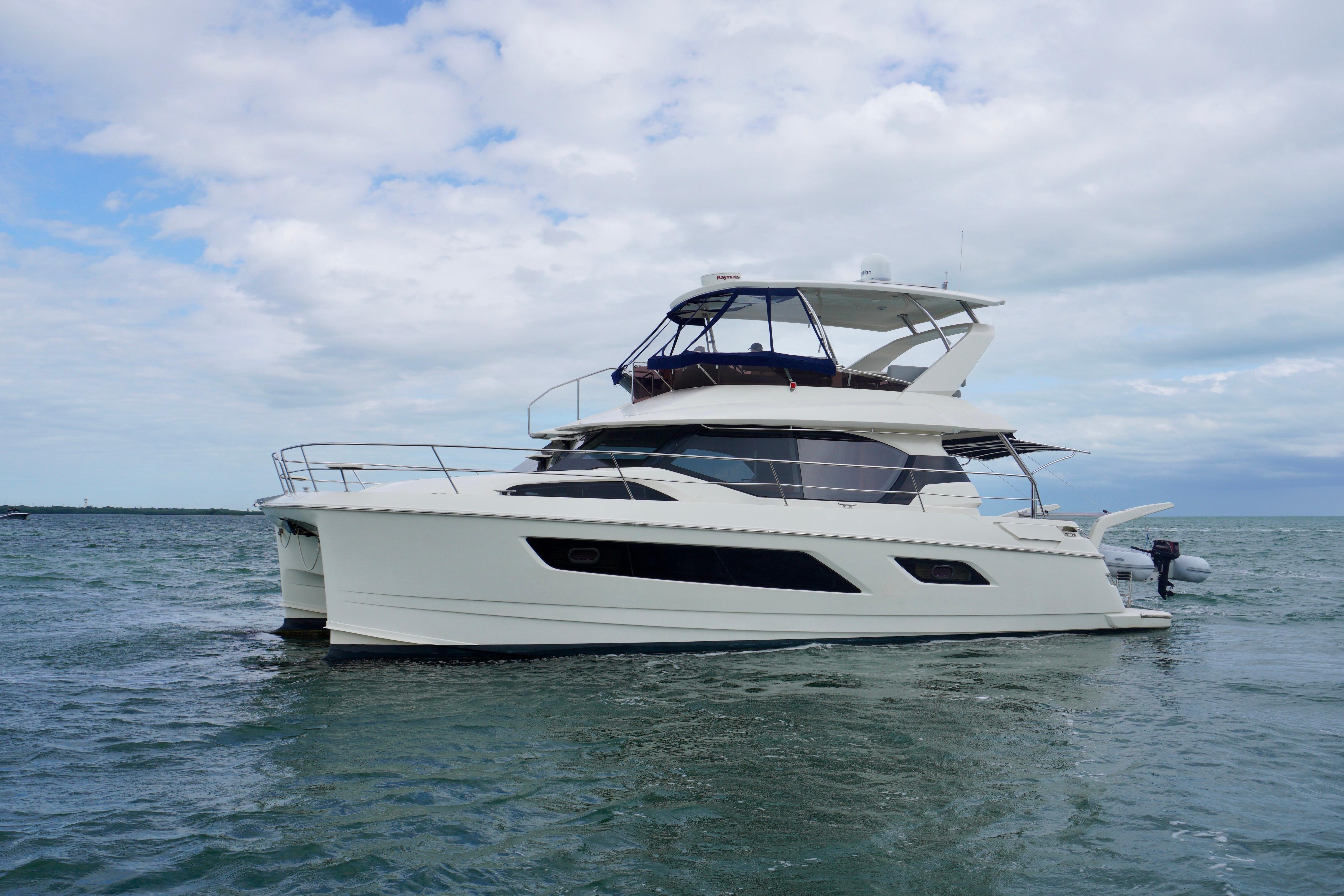 2017 Aquila 44 Yacht cruising on open water under a cloudy sky.