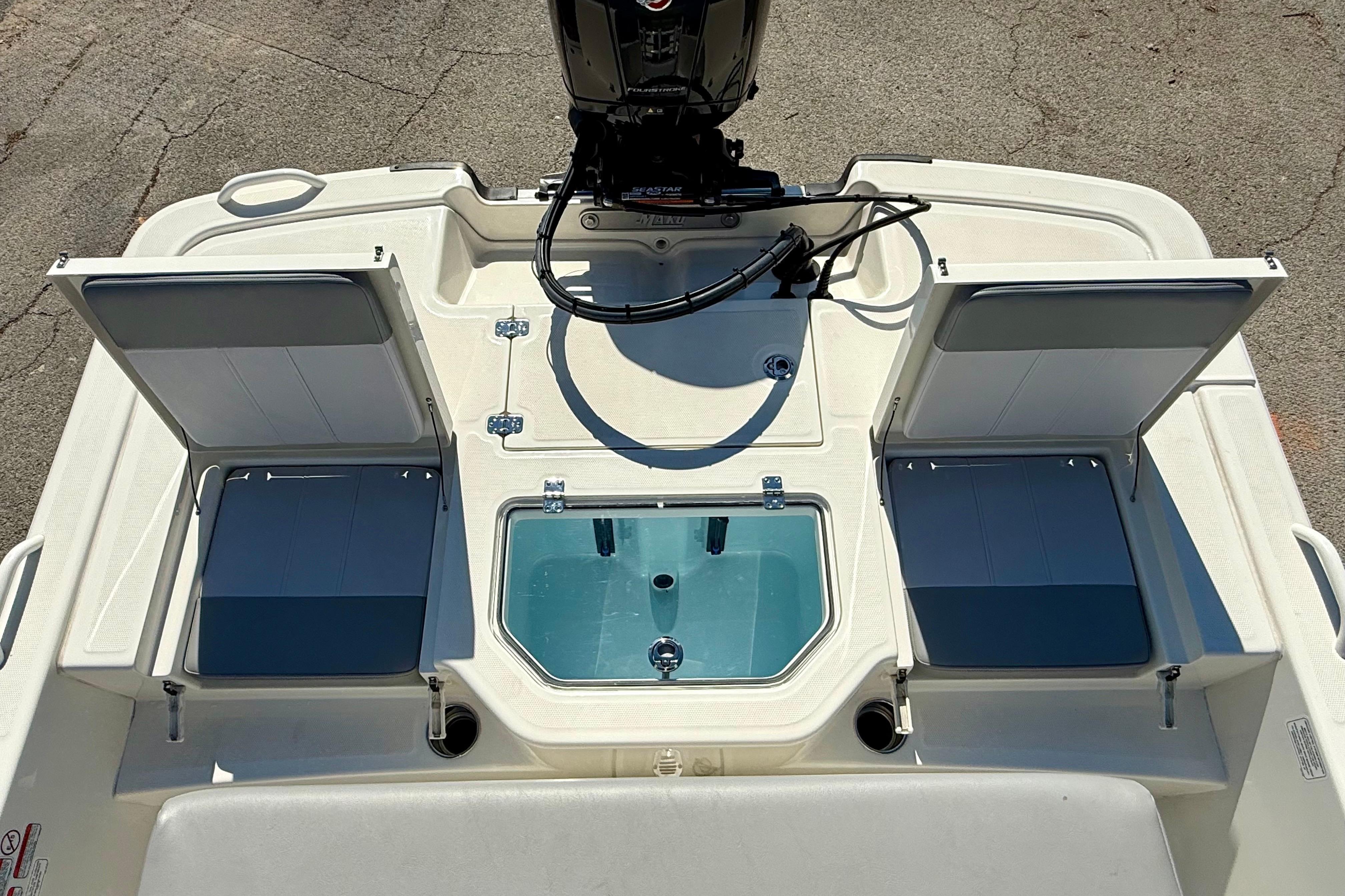 2024 Mako Pro Skiff 19 CC boat interior with seating and storage compartments.