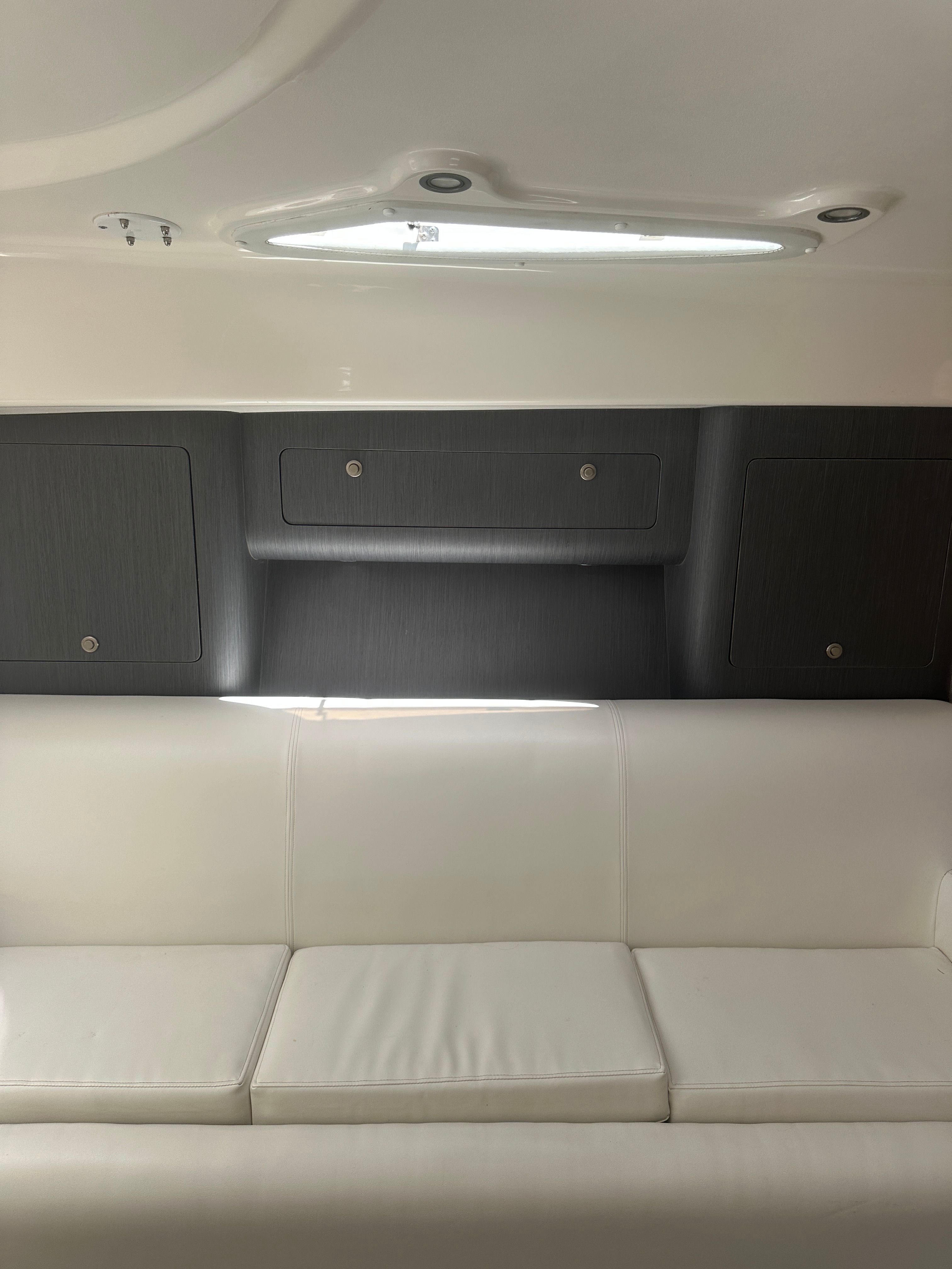 Interior of 2004 Intrepid 377 Walkaround with white sofa.