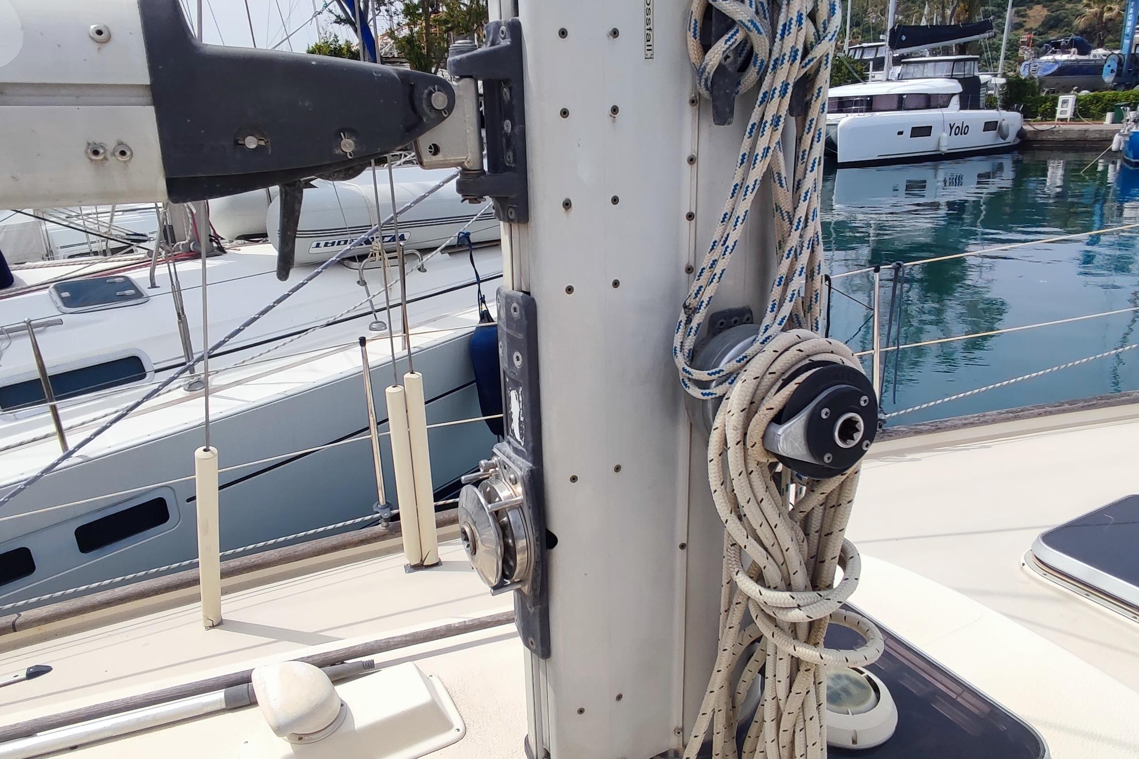 1982 Hallberg-Rassy 352 sailboat mast with rigging and ropes in marina setting.