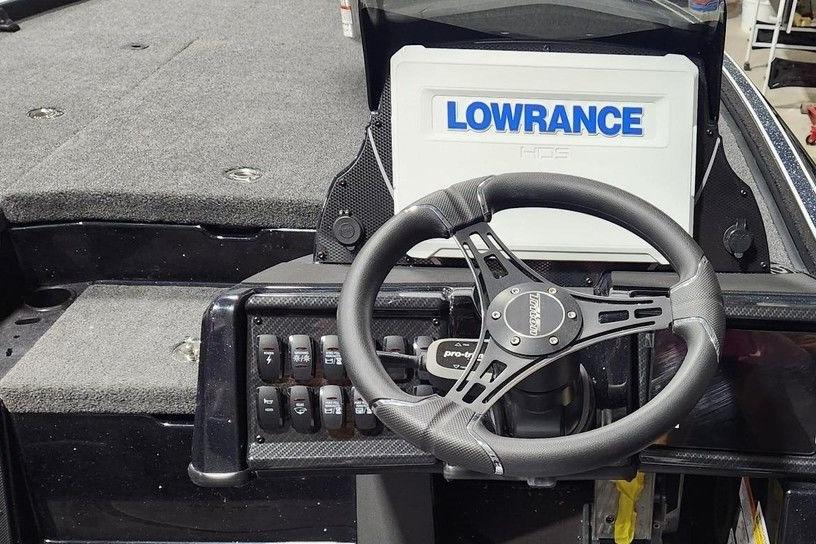 Steering wheel and dashboard of 2026 Triton 20XP Patriot boat with Lowrance display.