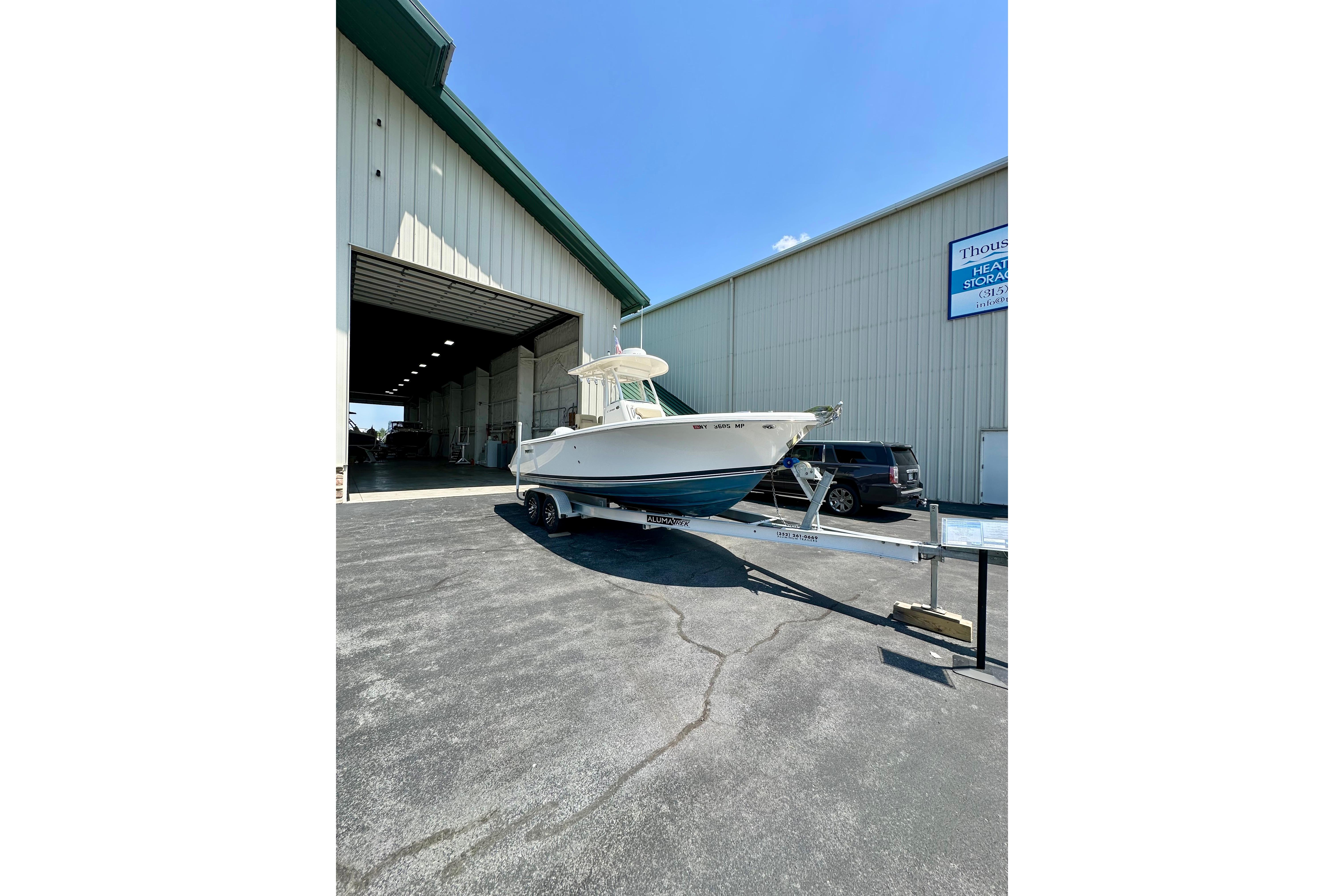 2020 Pursuit C 238 Center Console boat on trailer outside storage facility.