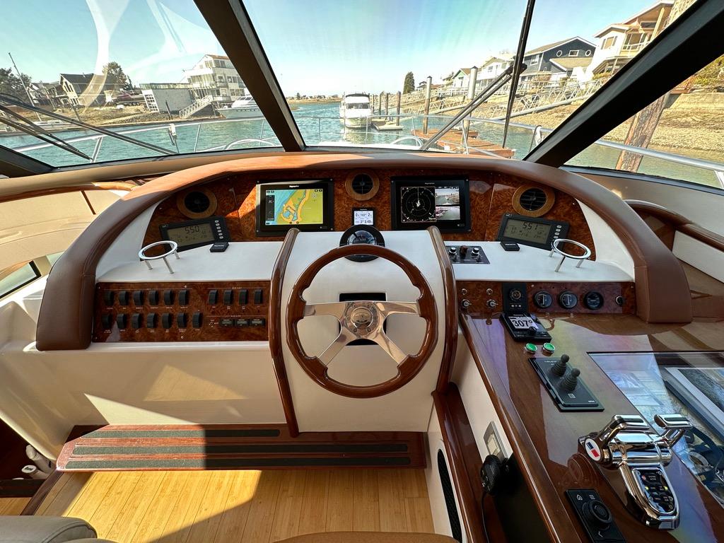Helm of 2006 Neptunus 55 Royale yacht with navigation instruments and steering wheel.