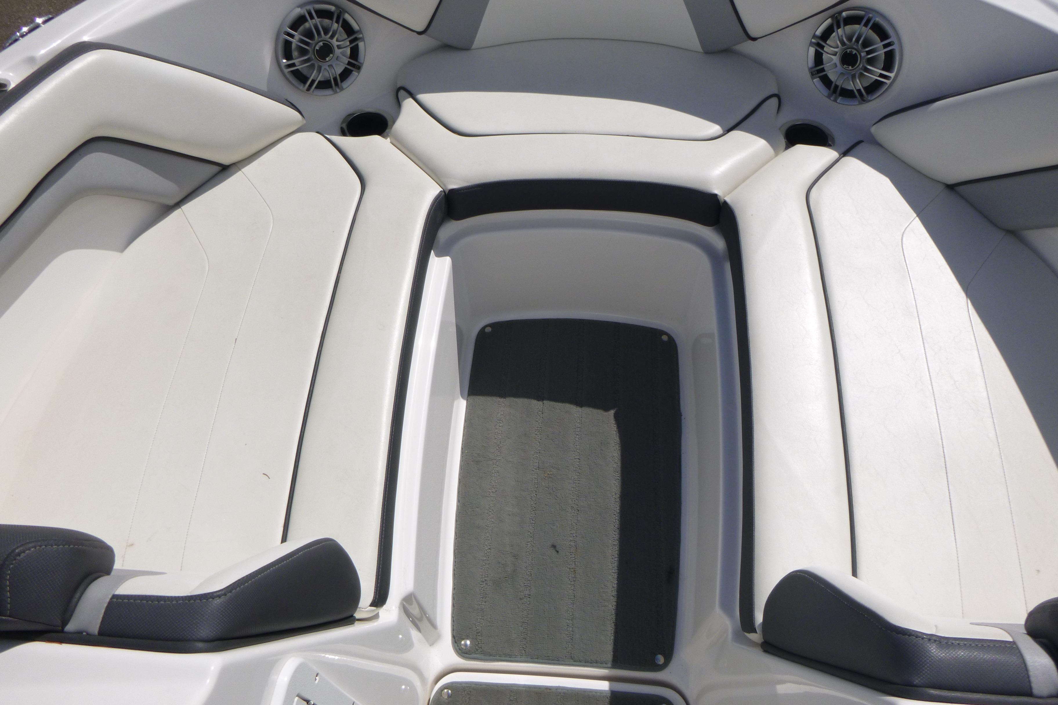 Interior seating of a 2015 Yamaha Boats SX192, featuring white upholstery and speakers.