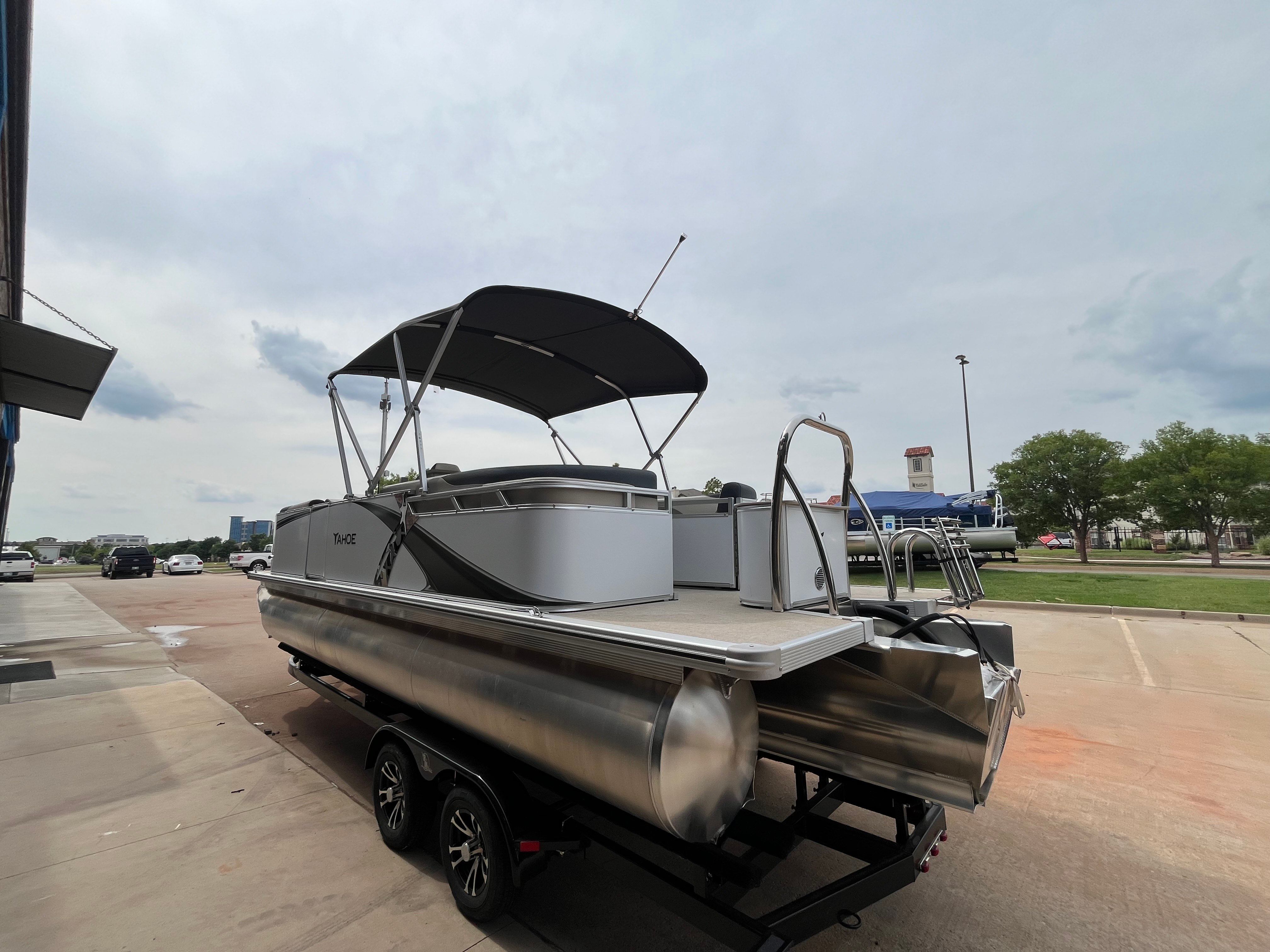 2025 Tahoe LTZ QL pontoon boat parked on trailer outdoors.
