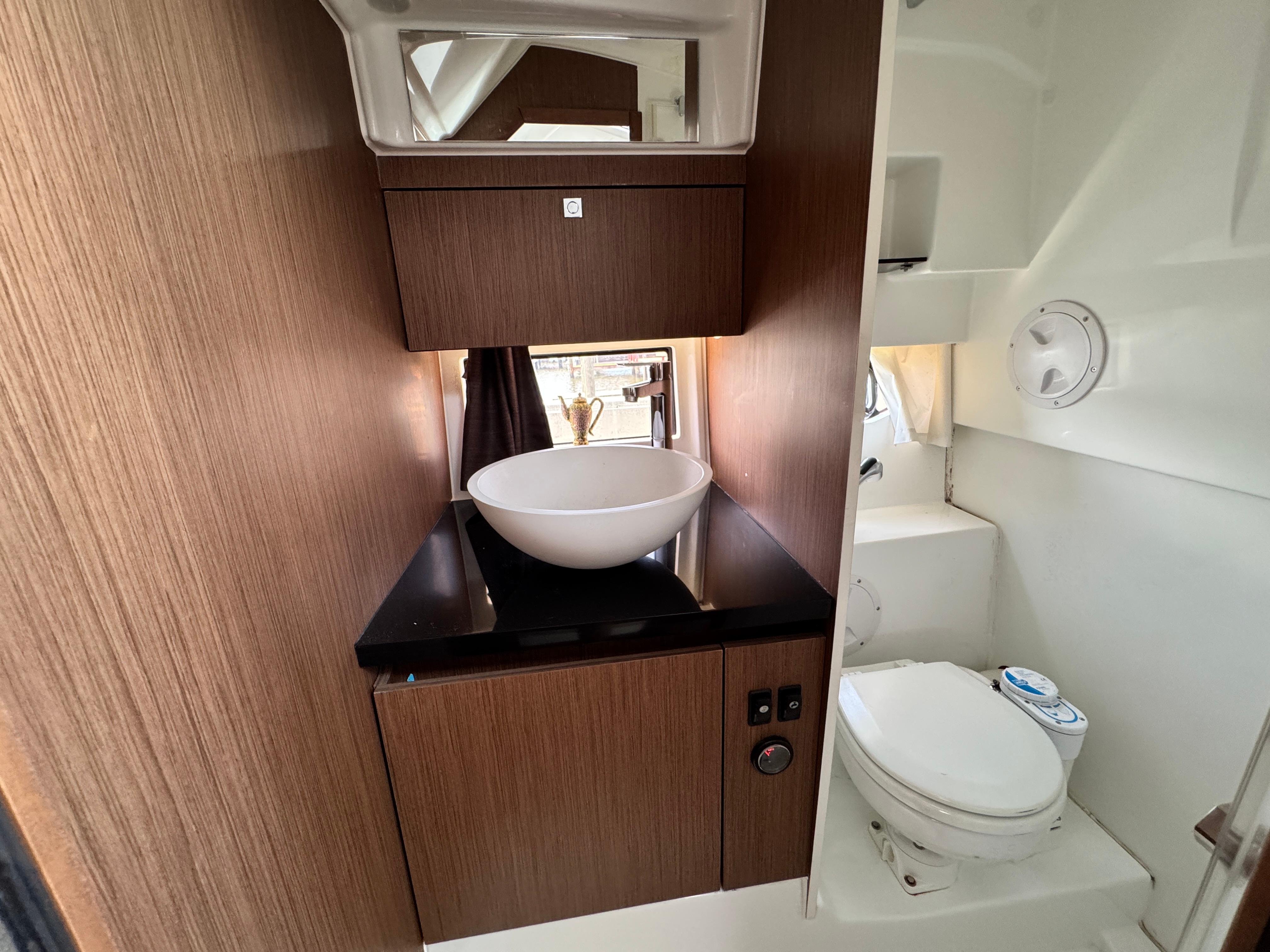 2022 Beneteau Flyer 9 SUNdeck bathroom with modern sink and toilet.