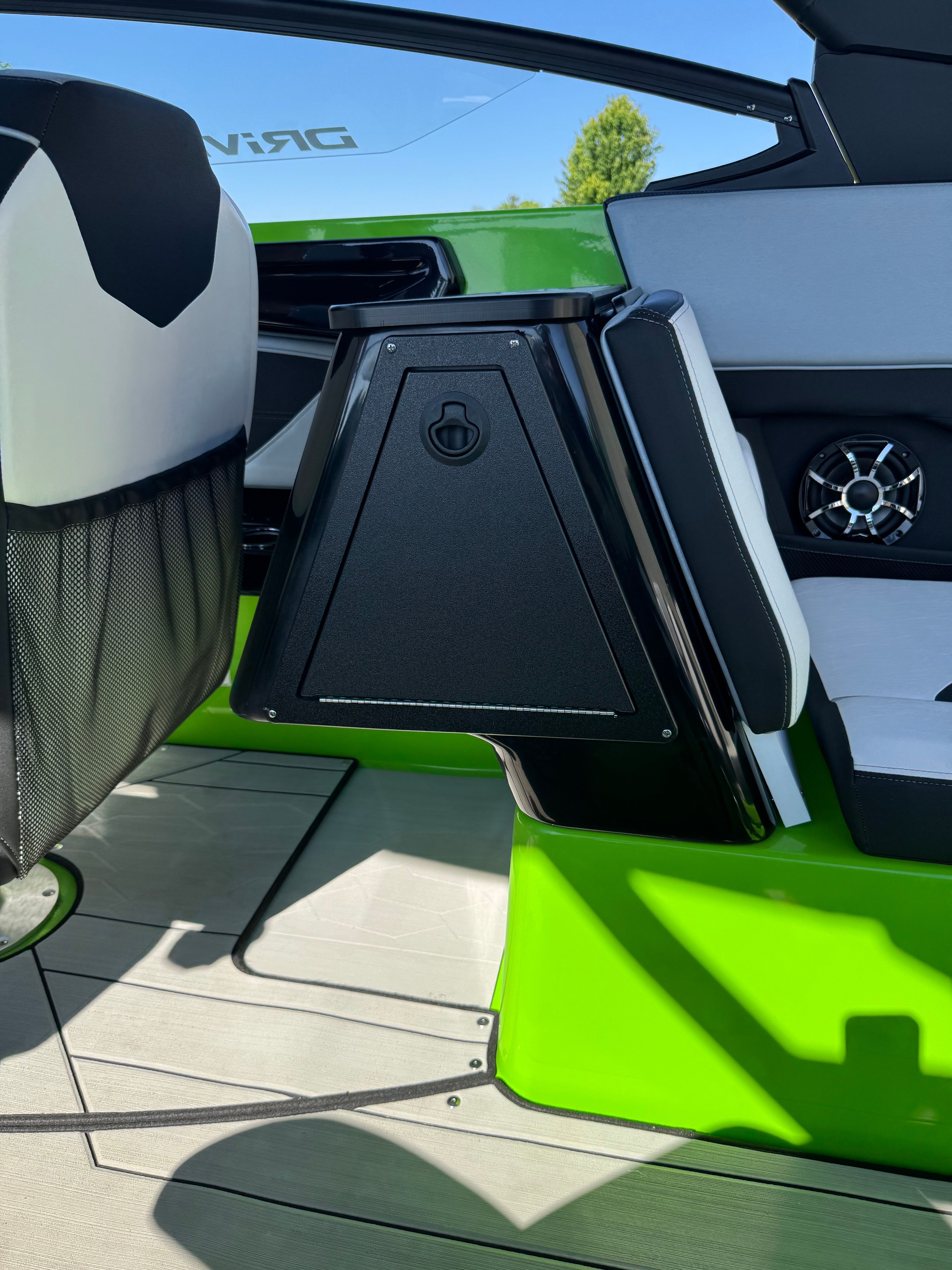 Interior of a 2022 Yamaha 255XD with green accents and a speaker.