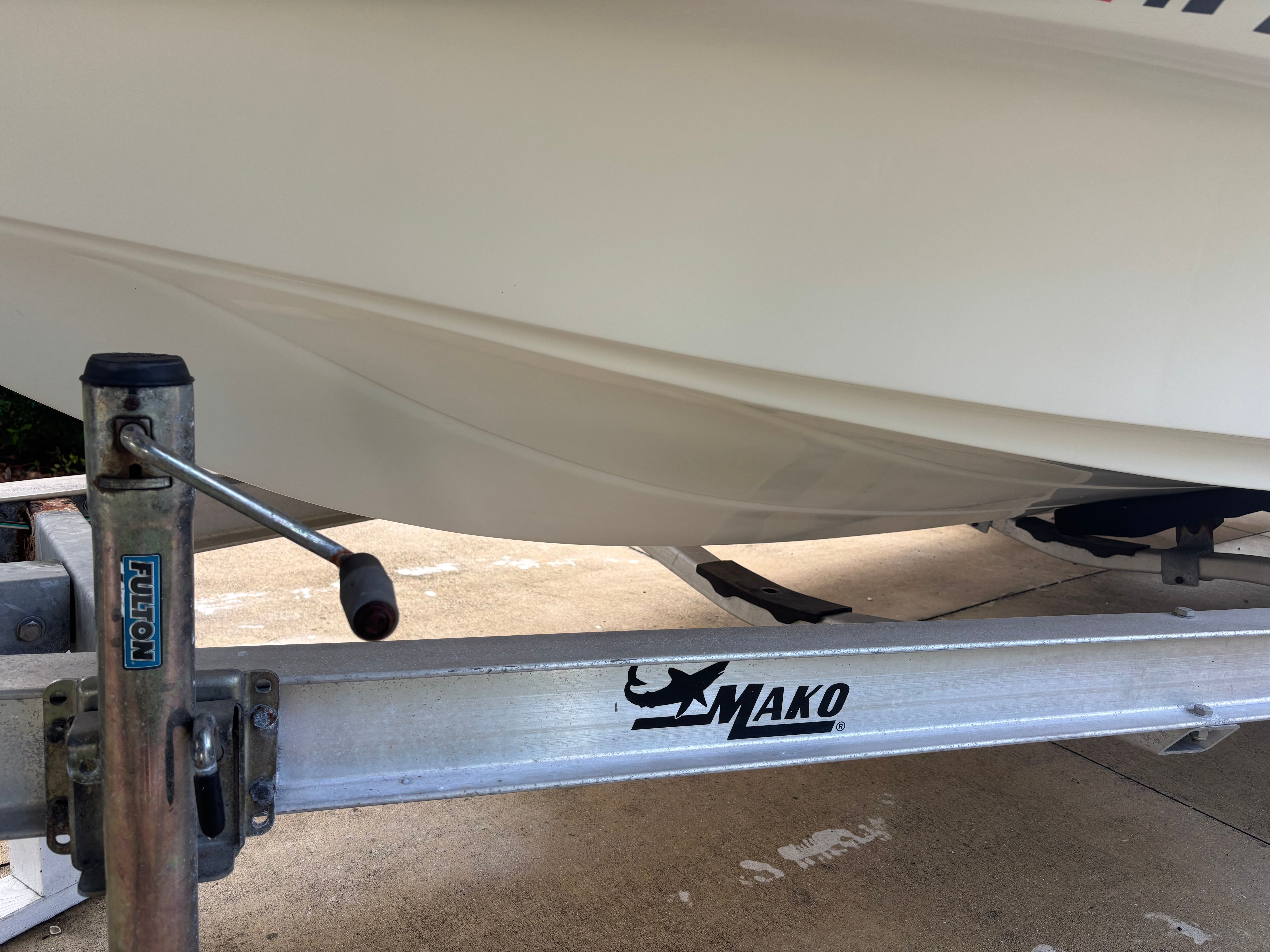 A 2016 Mako 18 LTS boat on a trailer, with a visible crank mechanism.
