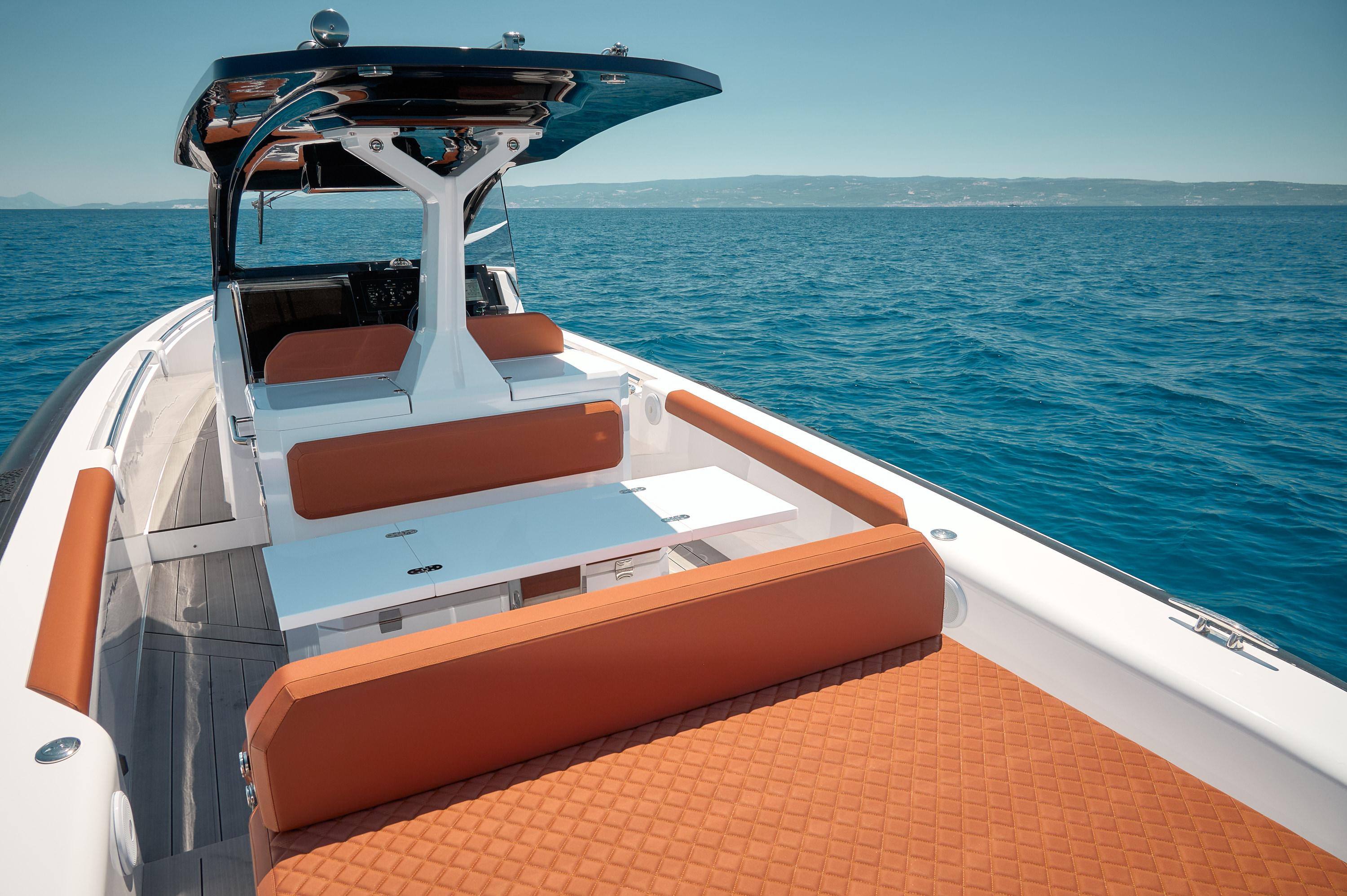 Luxury Pirelli 35 yacht interior with orange seating, cruising on open sea, 2025 model.