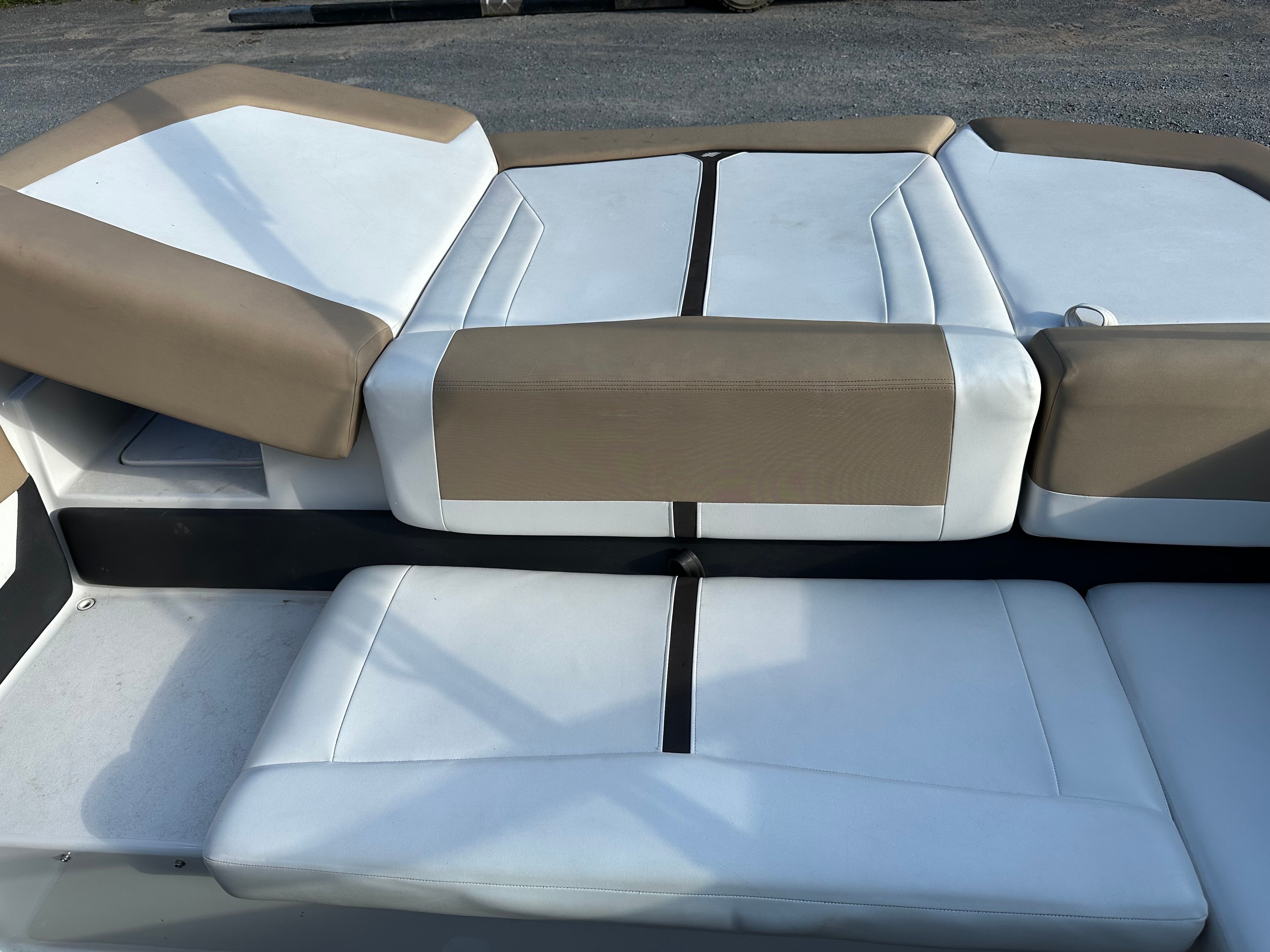 Interior of a 2012 Four Winns H210 boat with beige and white seating.