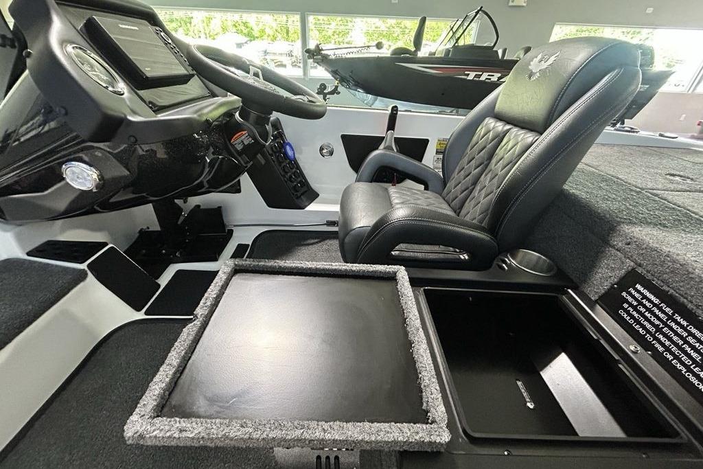 Interior of 2026 Phoenix 818 Pro boat with steering console and cushioned seat.