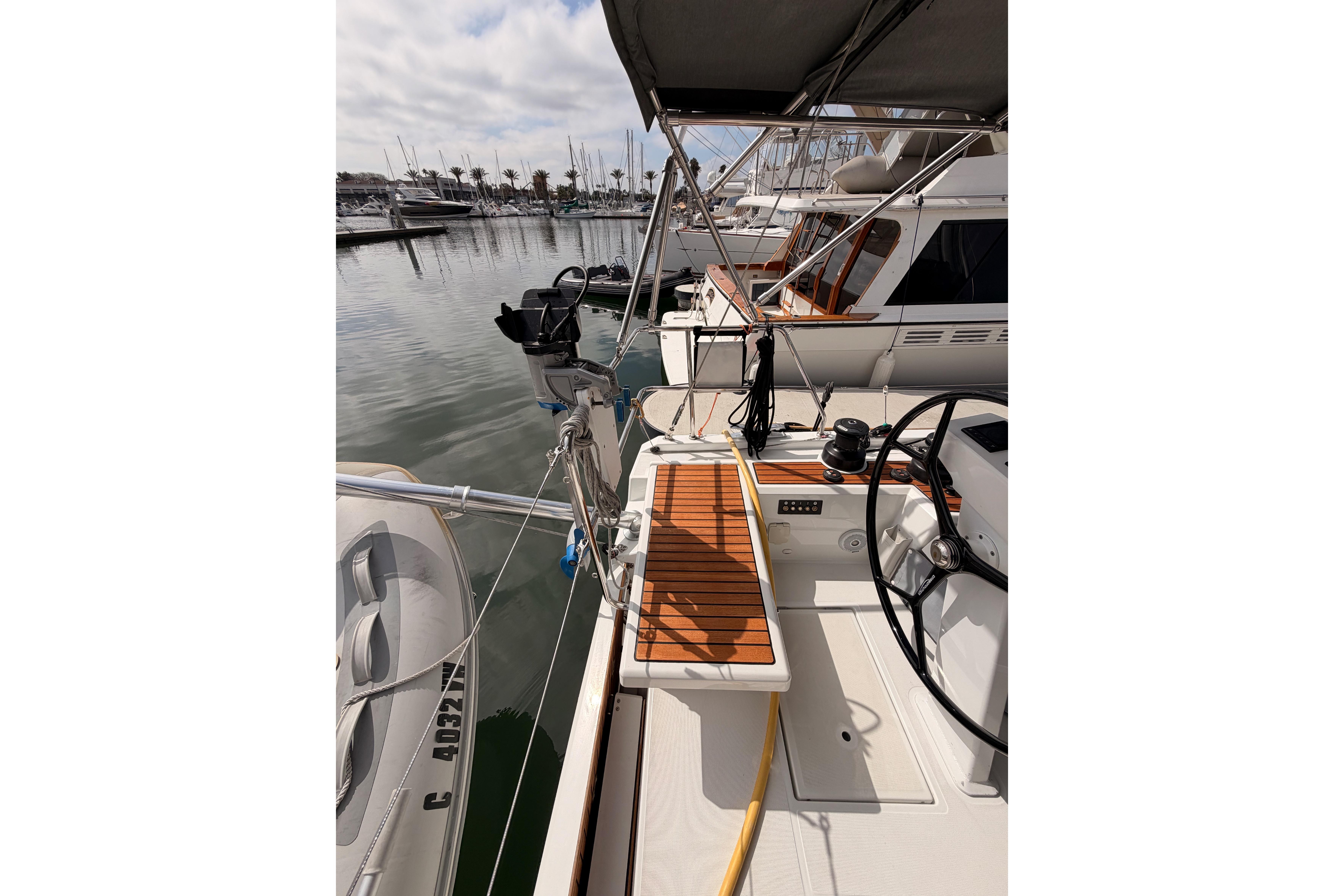 2020 Beneteau Oceanis 46.1 yacht deck with wooden accents in marina setting.