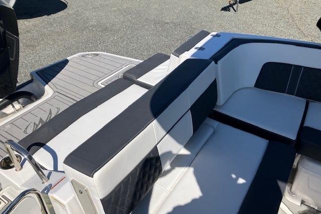 2024 Monterey M-65 boat interior with sleek white and black seating design.