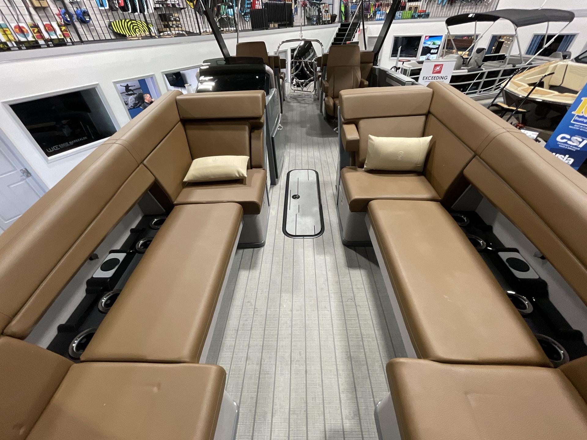 Luxurious interior of 2025 Balise Horizon 26C boat with brown seating and modern design.
