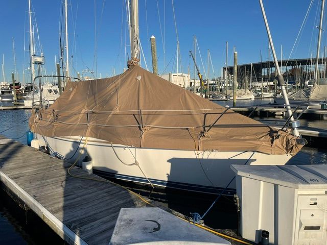 A 1989 Catalina 34 is docked, covered with a tarp.