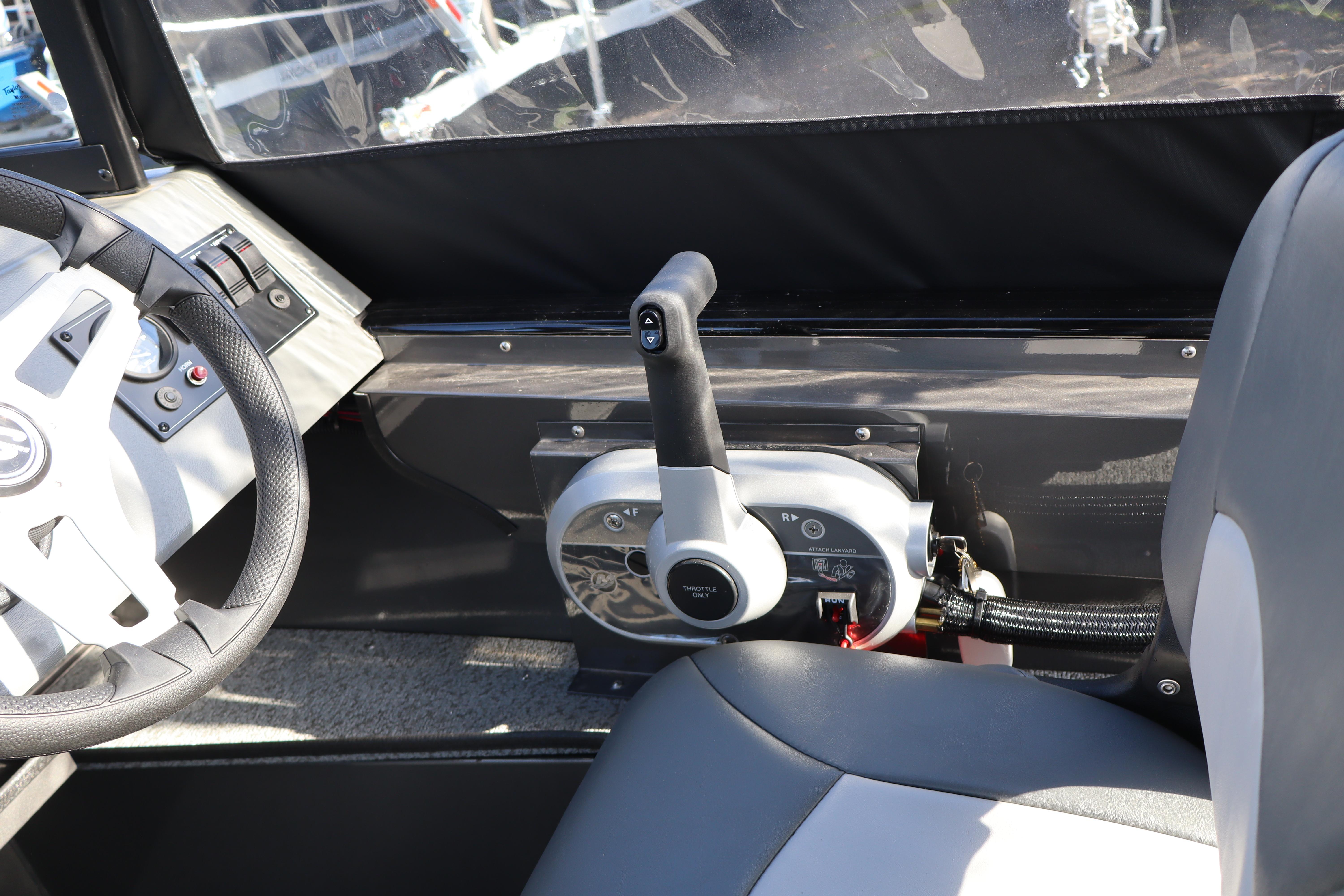 Interior of 2026 Smoker Craft Pro Tracer 162 boat, featuring steering wheel and throttle controls.