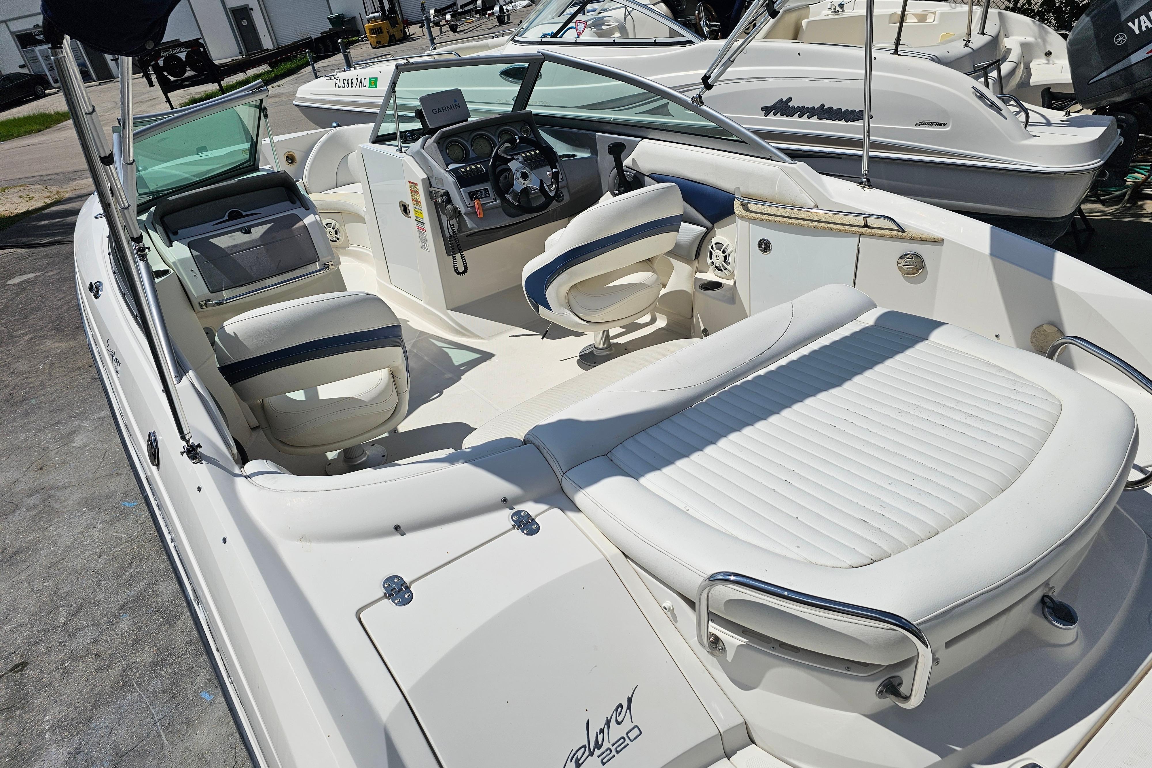 2008 Monterey 220 Explorer boat interior with white seating and steering console.