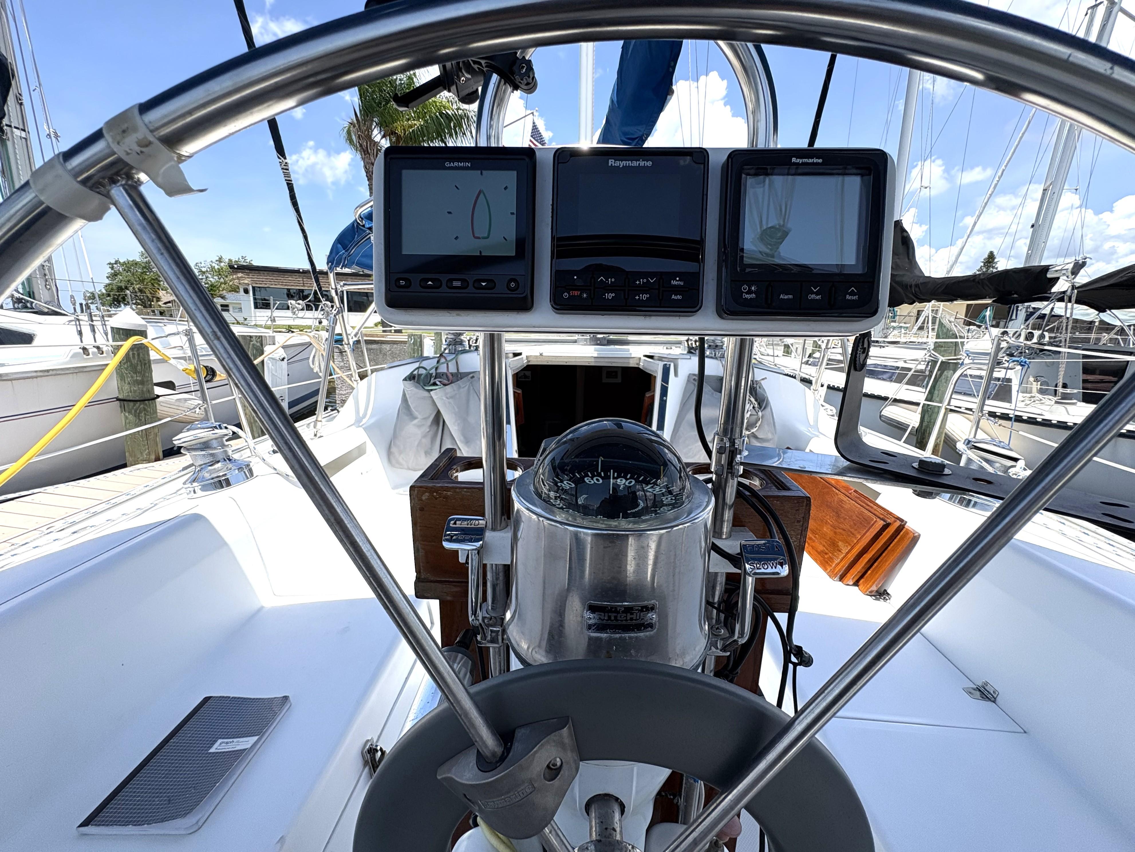 Cockpit of 1998 Catalina 34 MkII sailboat with navigation instruments and steering wheel.