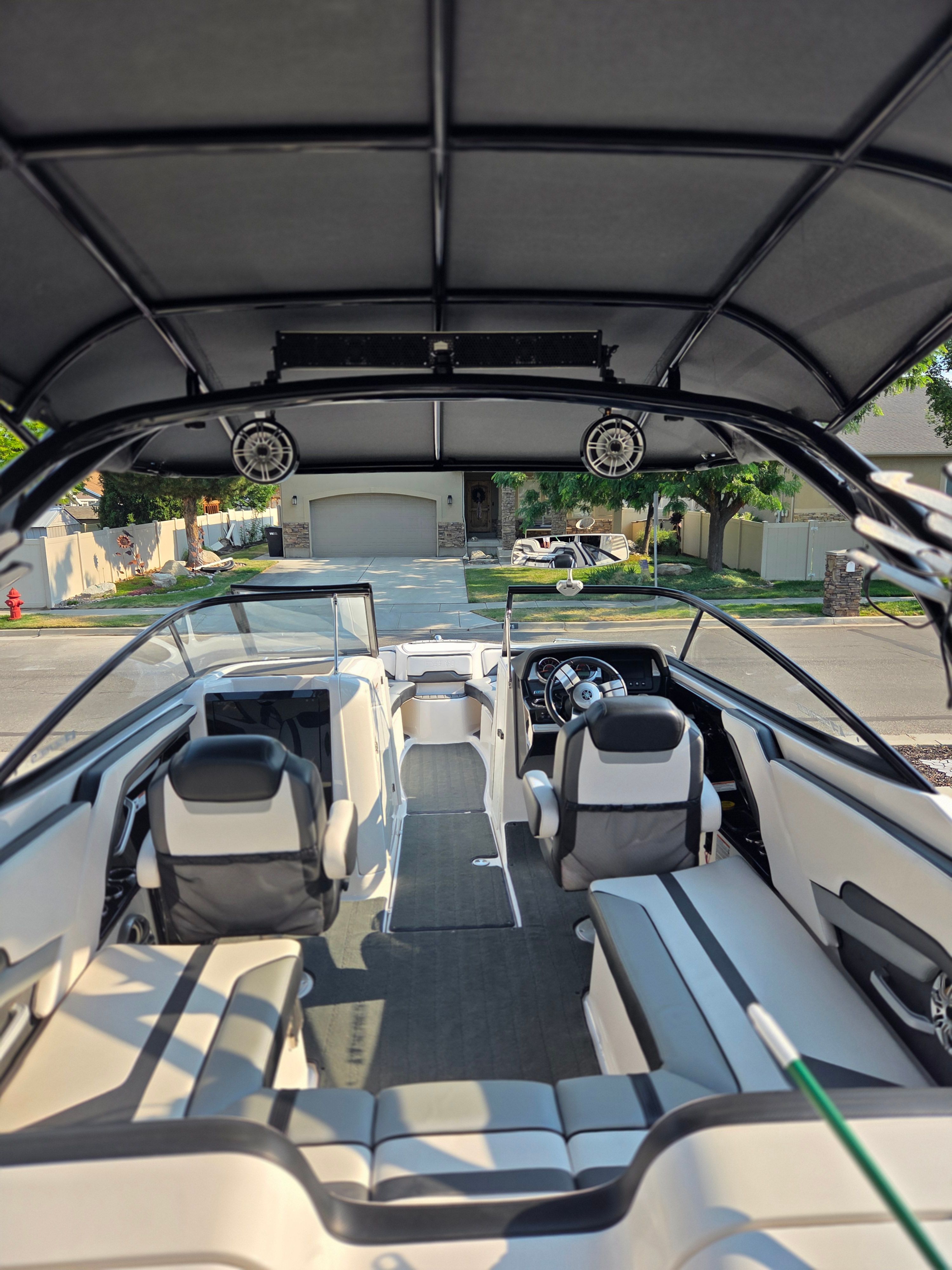 Interior view of a 2016 Yamaha 242X E-Series boat with modern seating and a stylish helm.