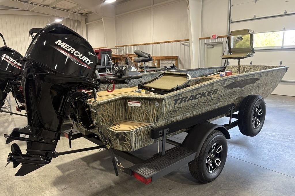2026 Tracker Grizzly 1650 T Prairie Wings Edition boat with Mercury engine in showroom.