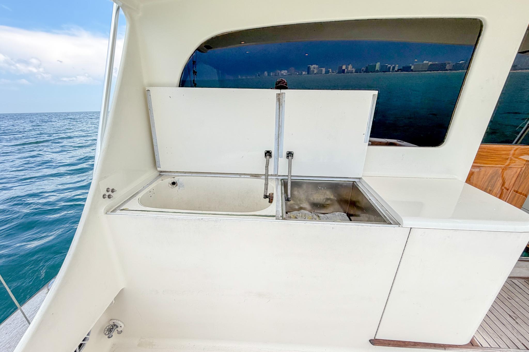 Outdoor sink on 1998 Blackwell Custom Carolina Sportfish yacht with ocean view.
