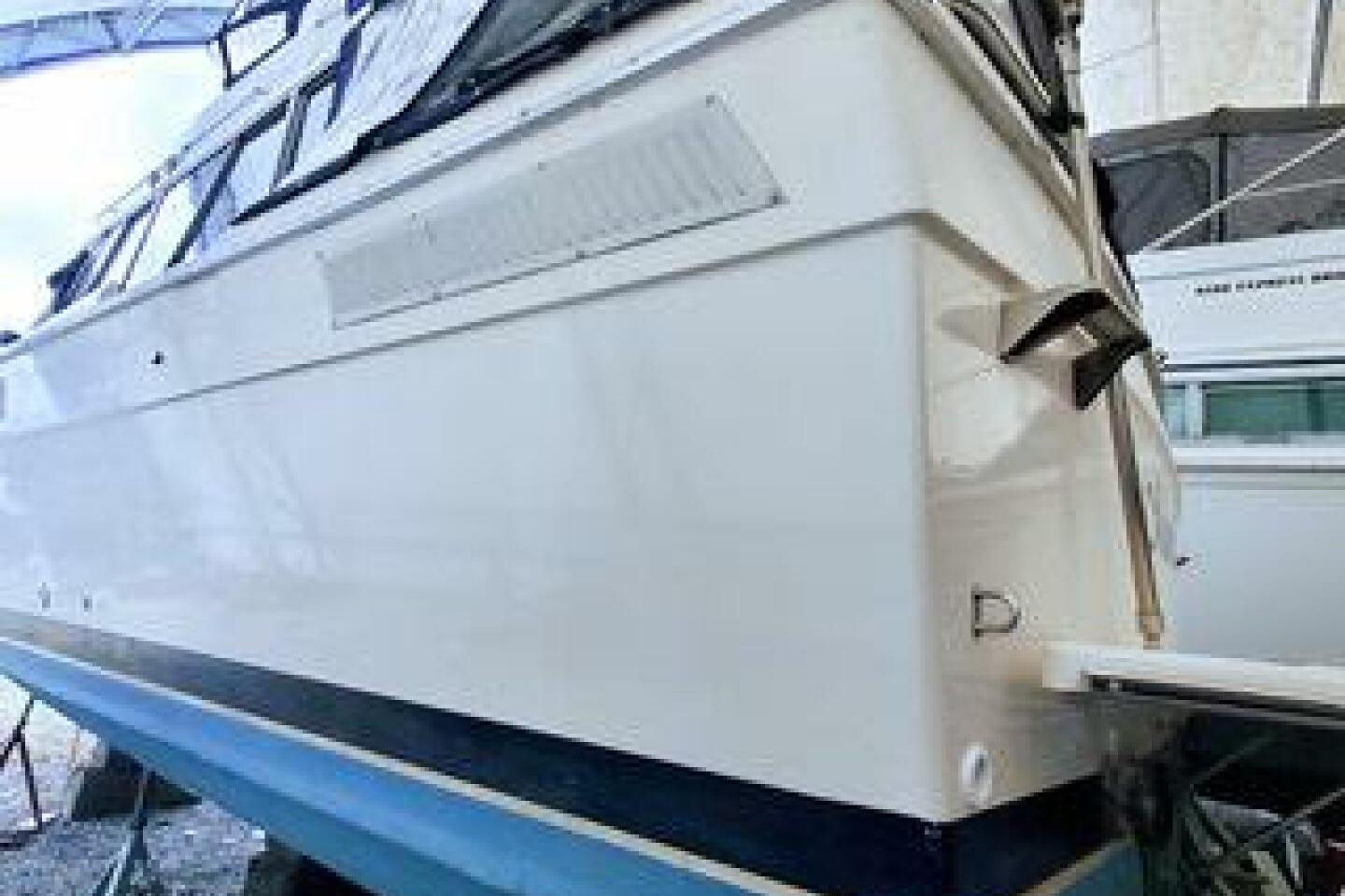 1986 Bayliner 3270 Motoryacht on dry dock, showcasing sleek white hull design.