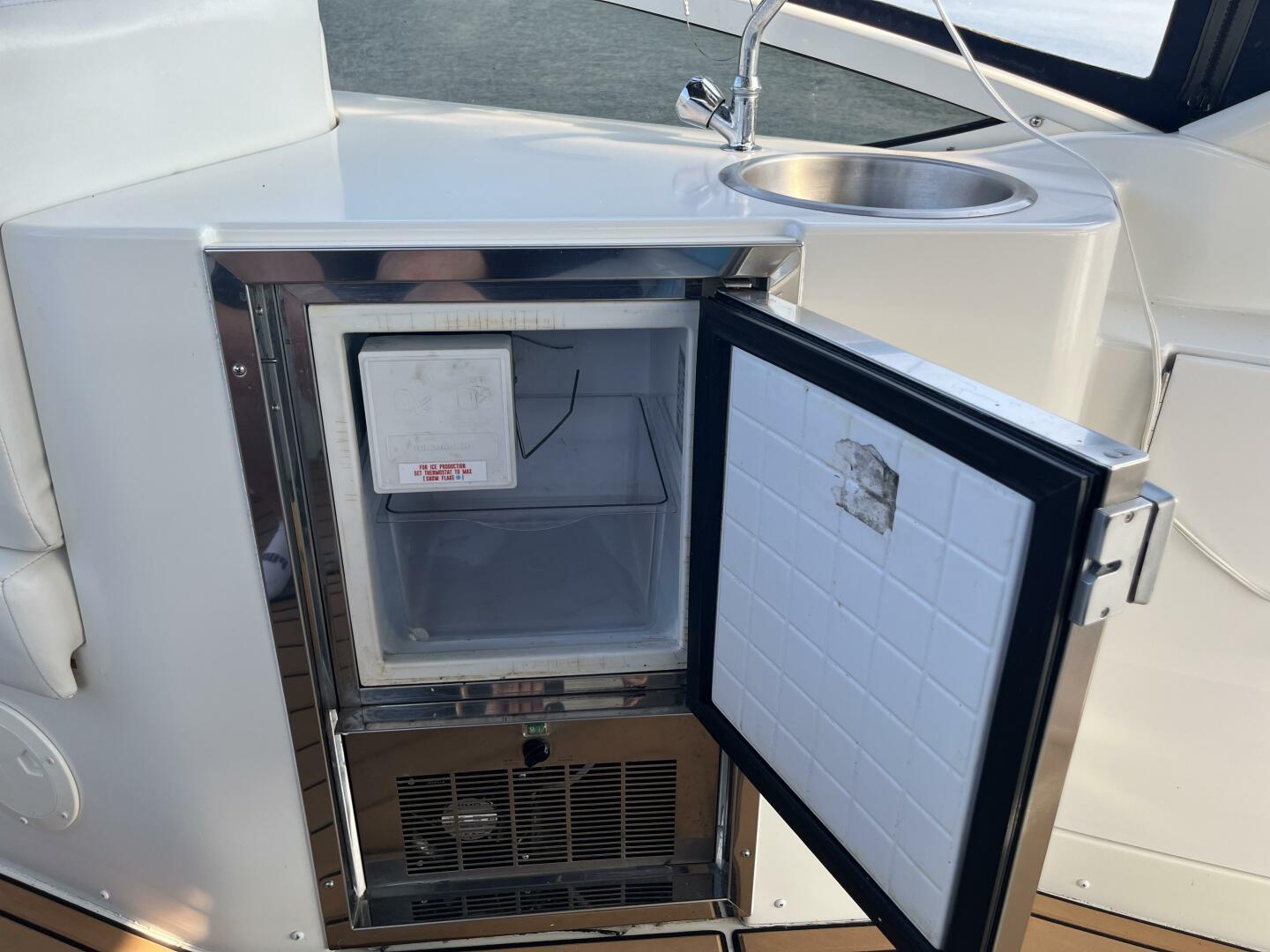 Open mini fridge and sink on 2003 Carver 444 Cockpit Motor Yacht.
