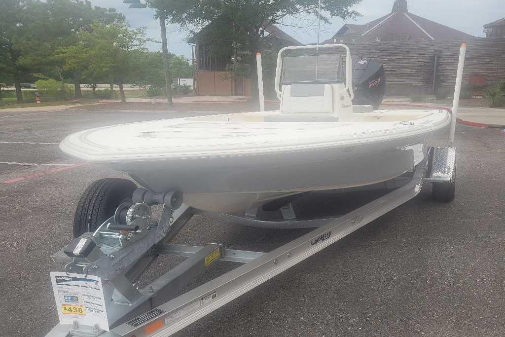 2026 Mako 18 Pro Skiff boat on trailer in parking lot.
