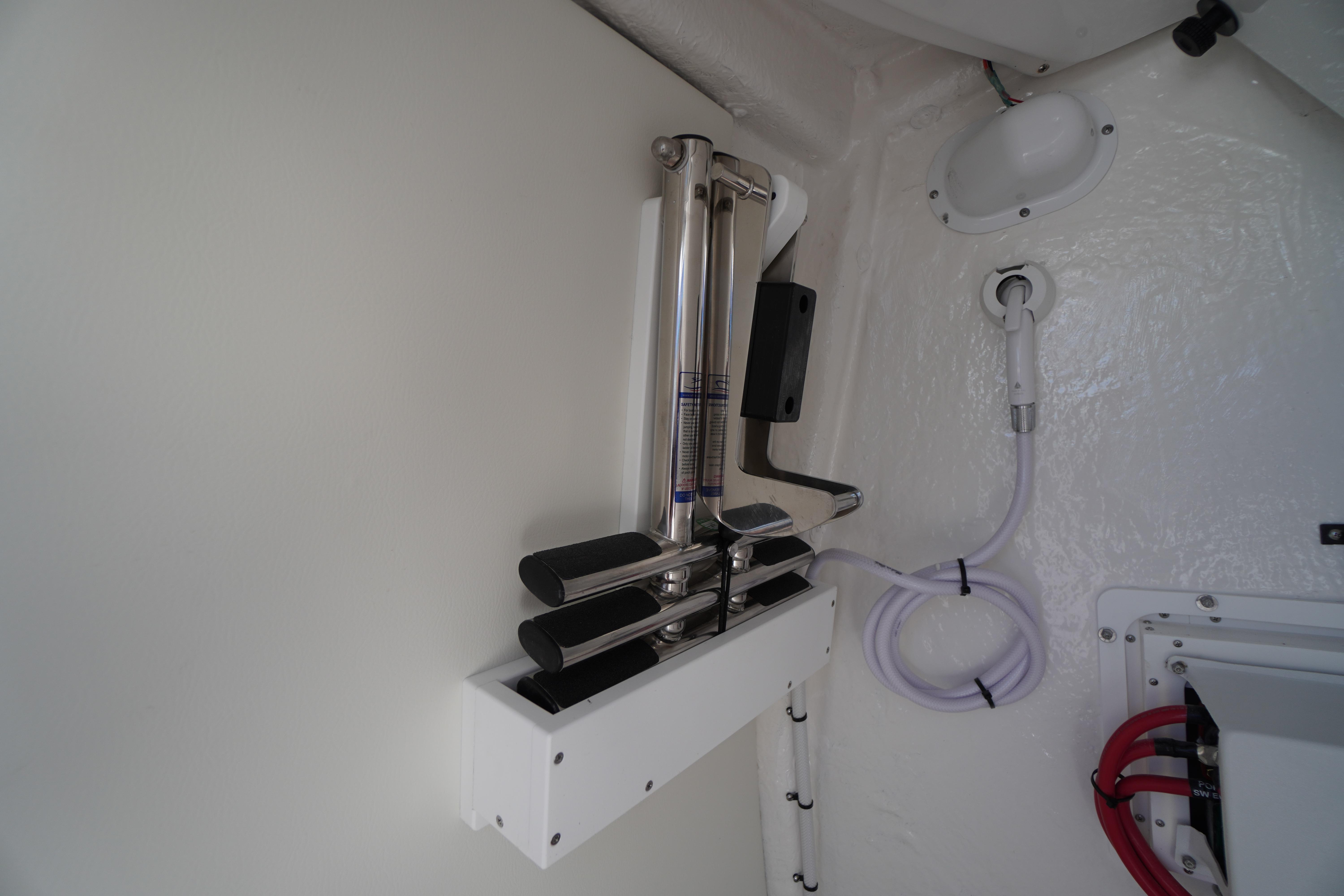 2026 Tidewater 272 LXF interior detail with mounted equipment and coiled hose.