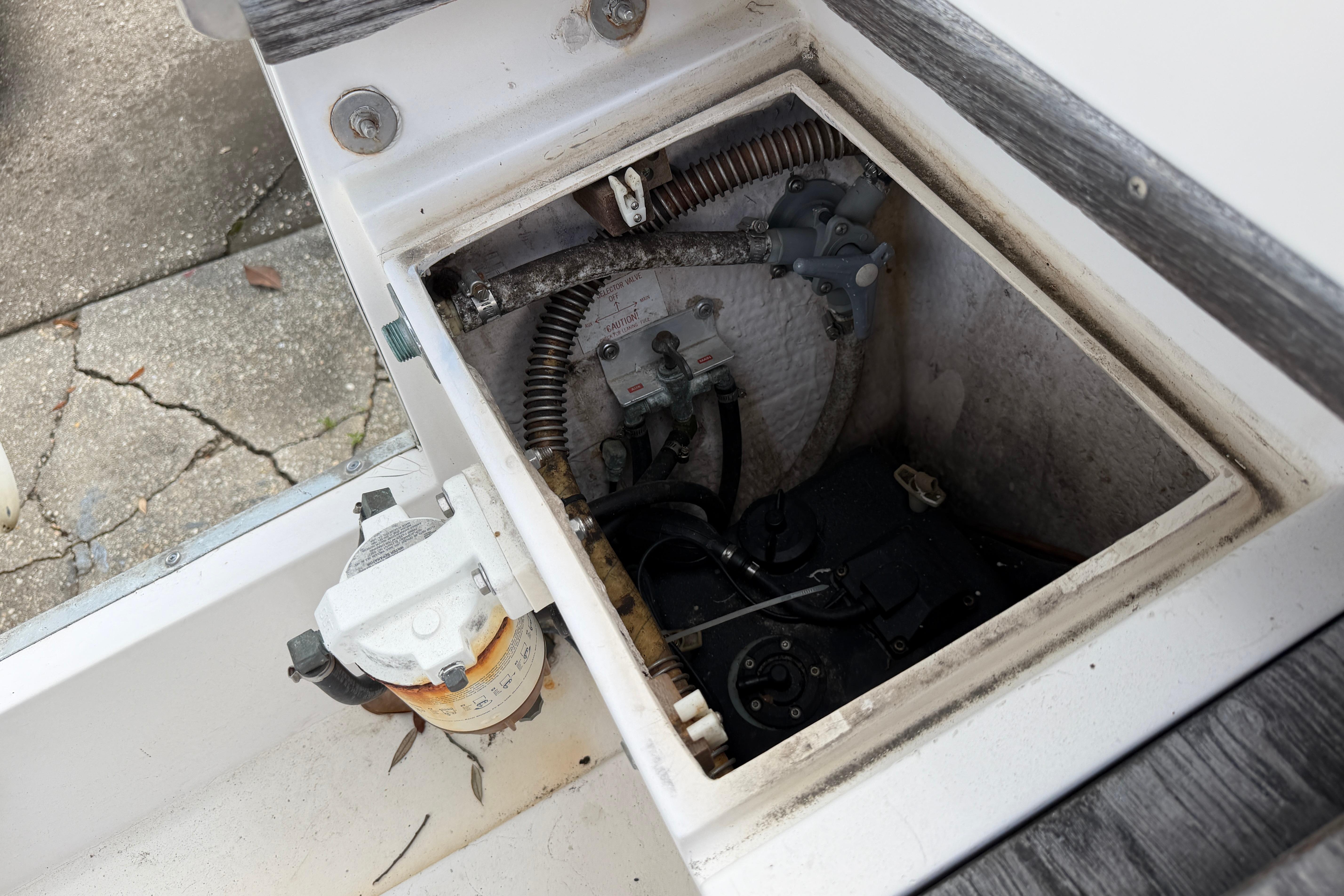 1987 Grady-White Seafarer 226 boat compartment showing mechanical components and wiring.