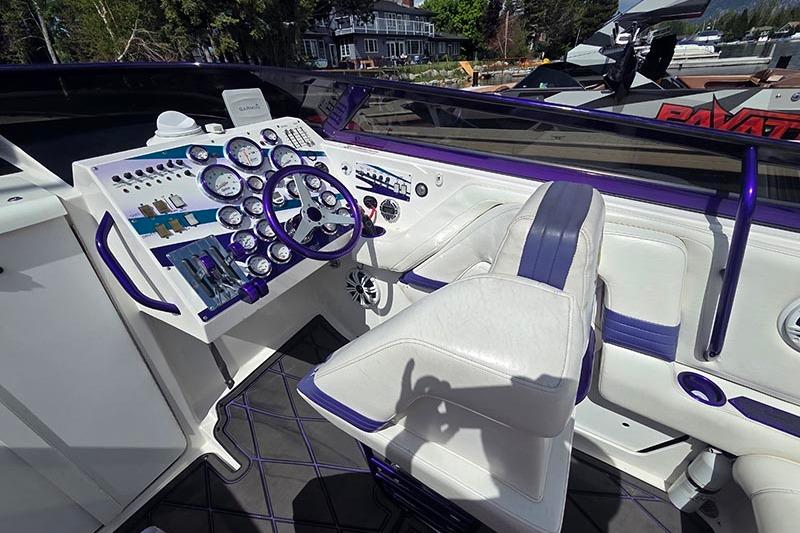 Cockpit of a 2004 Fountain 38 Lightning boat with purple accents and detailed instrumentation.
