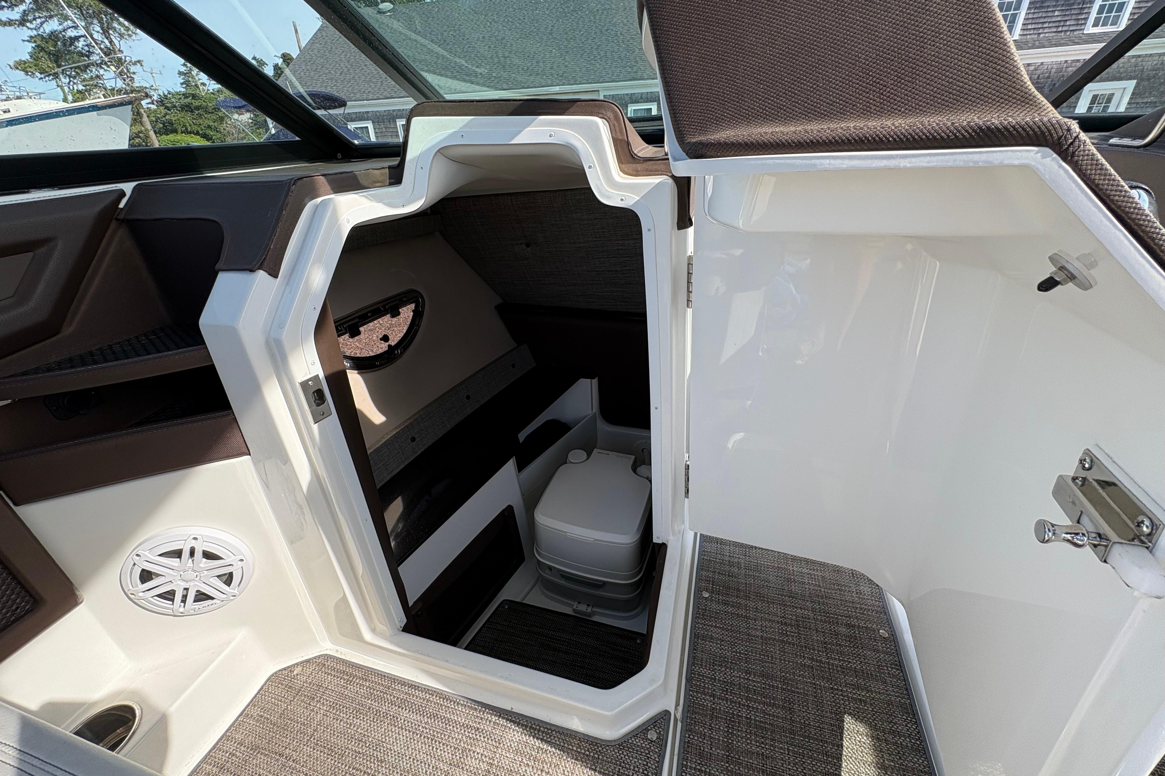Interior cabin of 2022 Cobalt R6 boat with compact toilet and speaker.