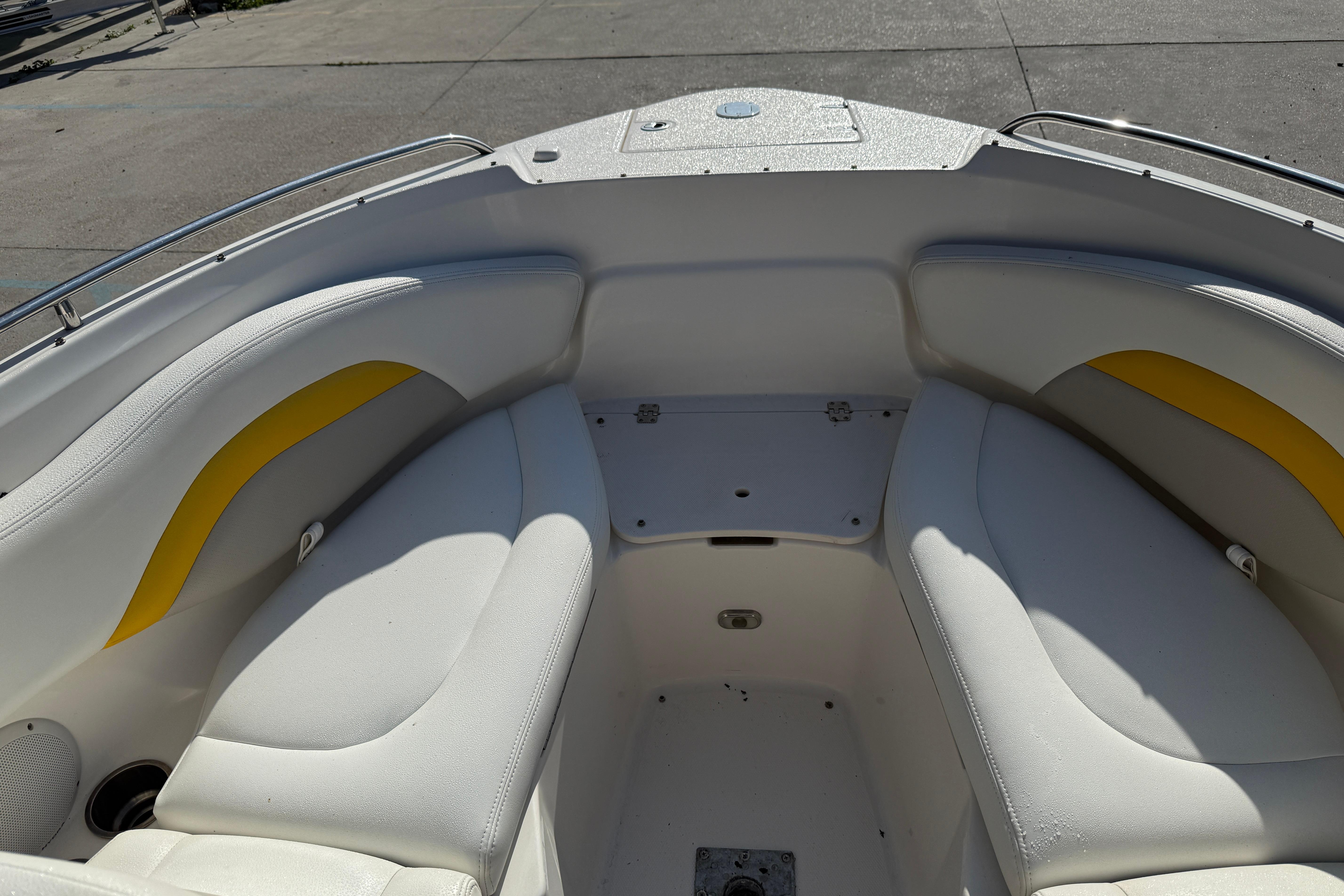 2008 Chaparral 236 SSX boat interior with white and yellow seating.