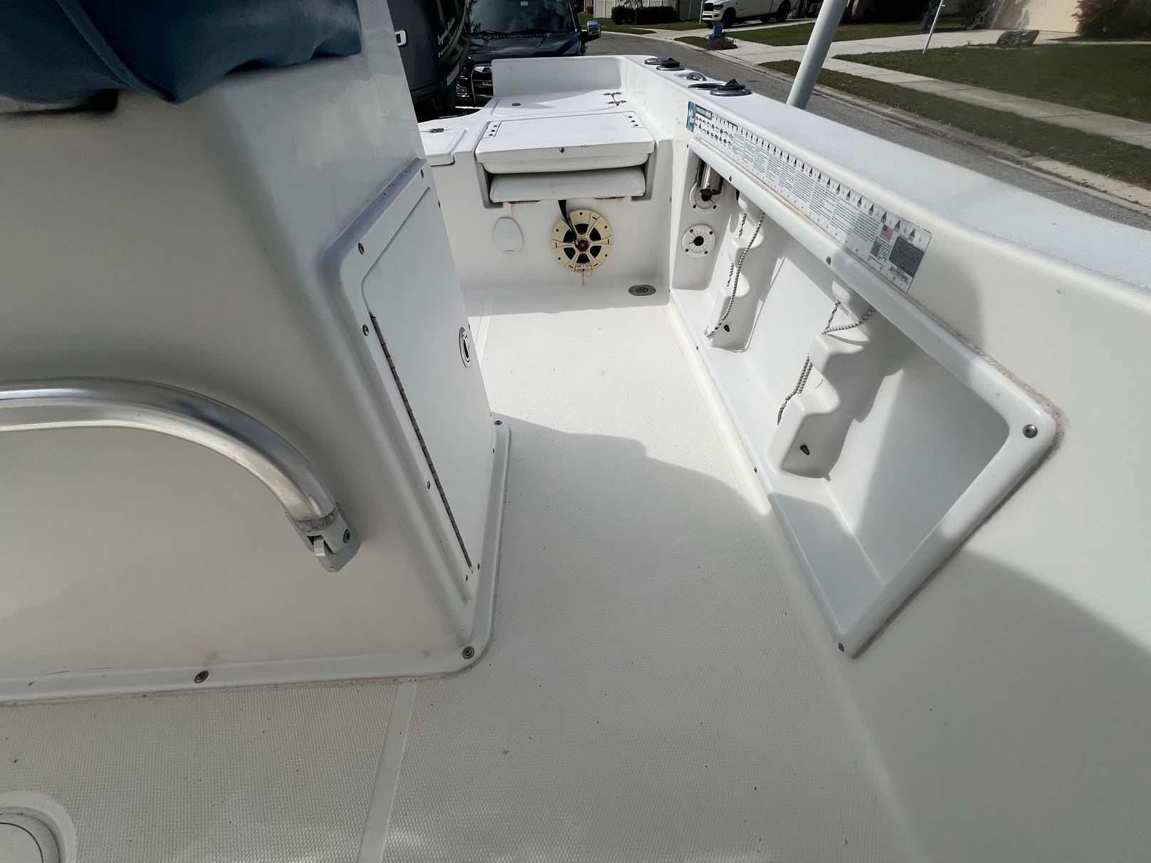 2014 Sea Hunt SXS boat interior with storage compartments and seating.