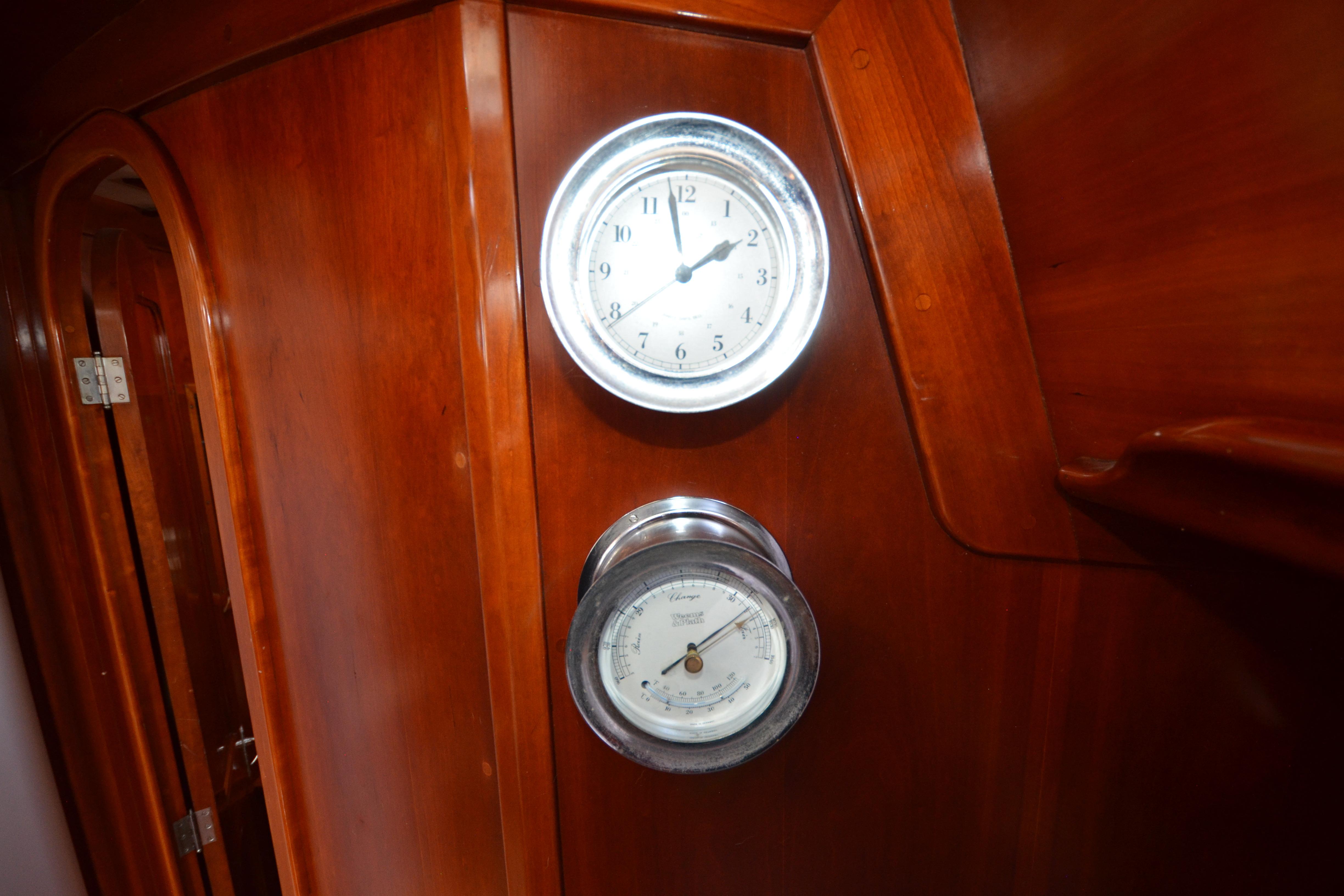 Wooden interior with clock and barometer on 1992 Hinckley Sou'wester 59 yacht.