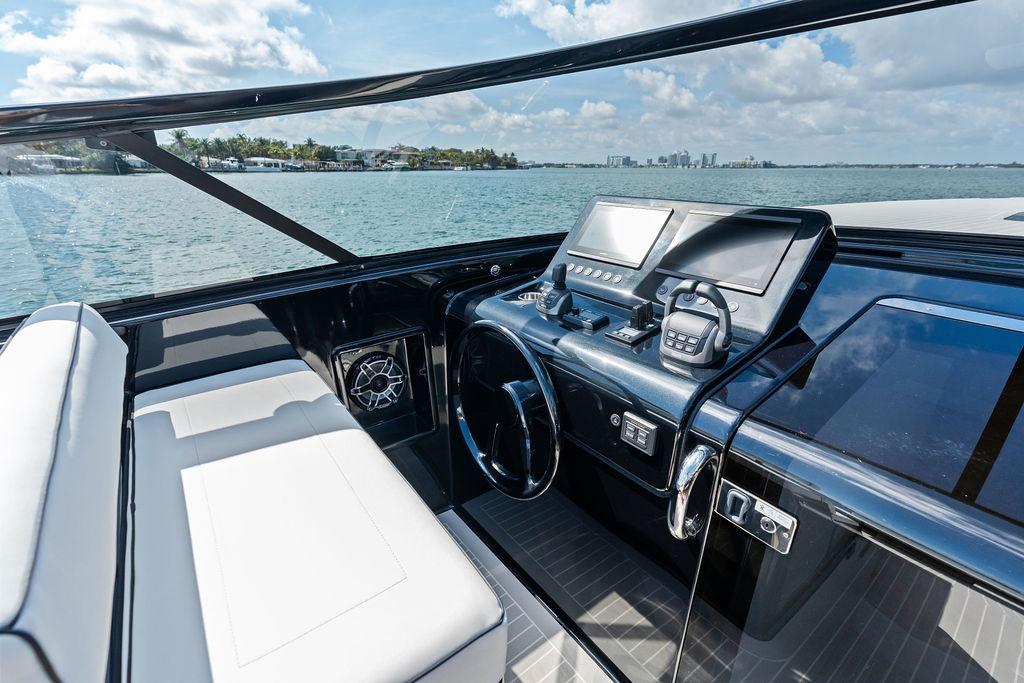 Luxurious VanDutch 40.2 yacht cockpit with modern controls, overlooking serene waters.