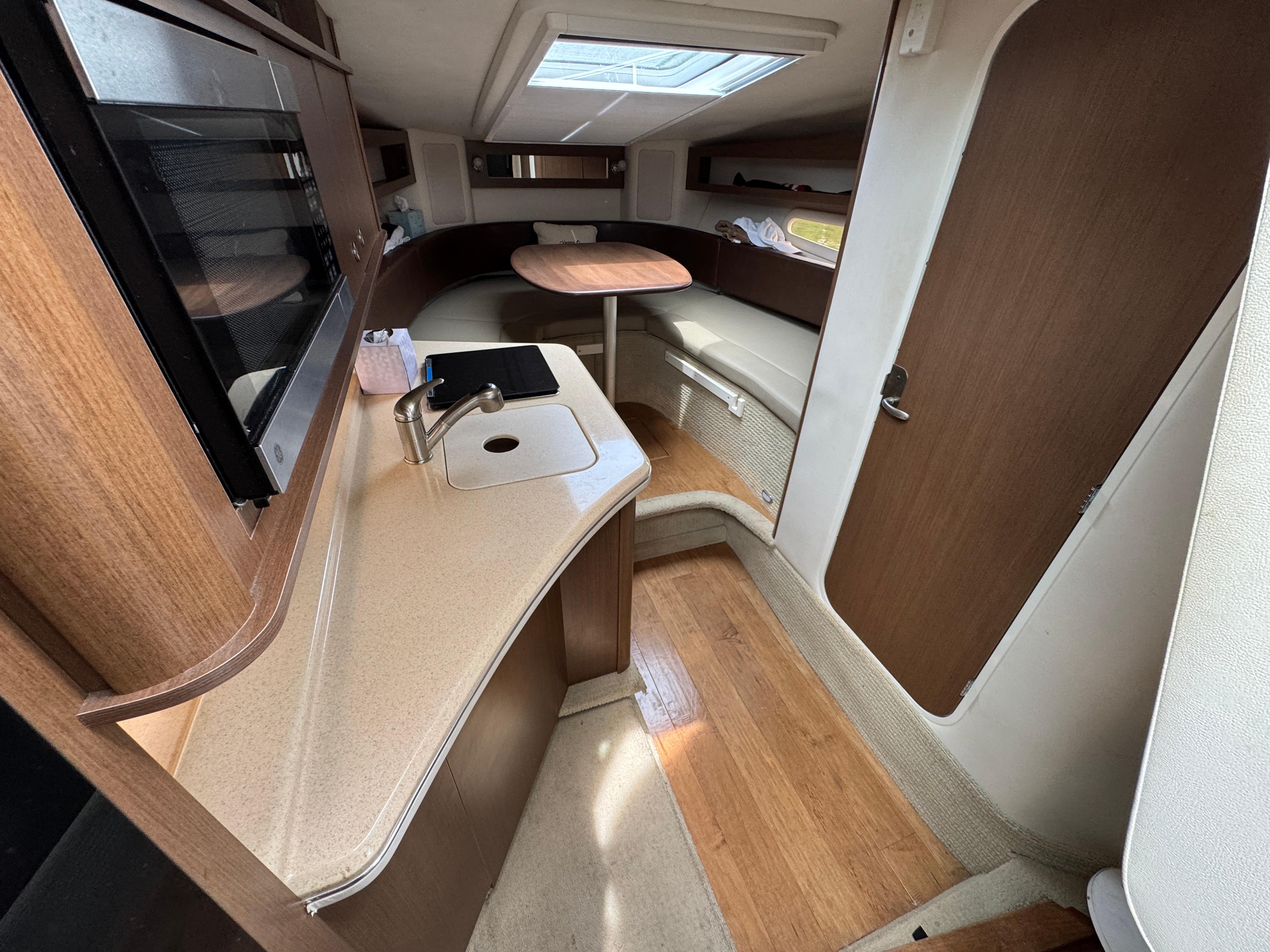 2014 Sea Ray 280 Sundancer cabin interior with kitchenette and seating area.